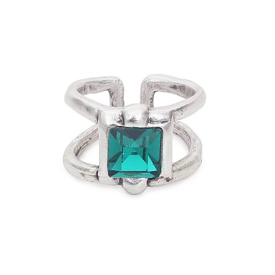Silver ring with a green gemstone on a white background