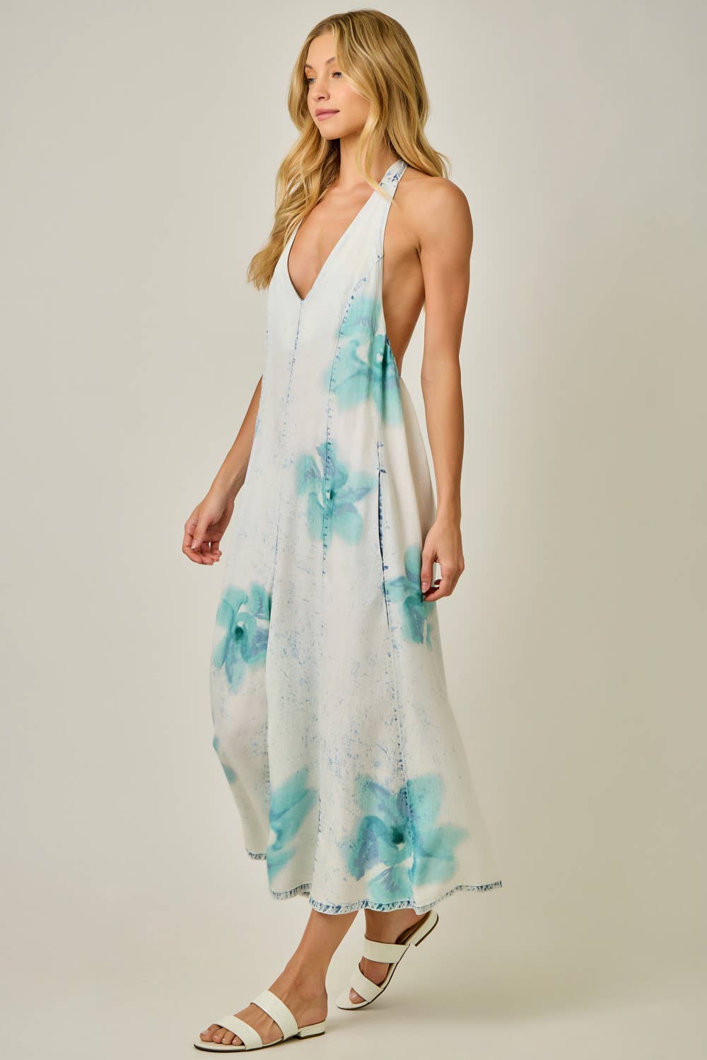 Woman wearing a floral jumpsuit with a plain background