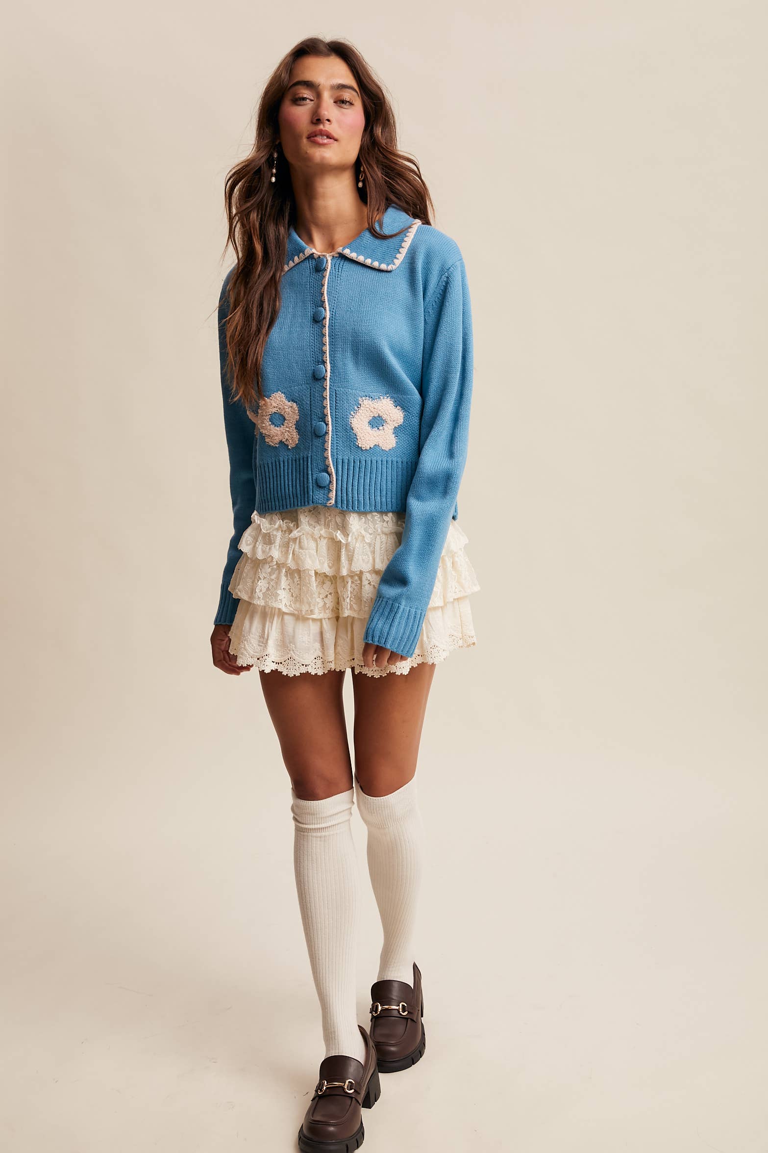 Women’s floral collar knit cardigan with button-front design, soft textured fabric, and contrast flower-patterned collar — stylish layering sweater for everyday wear.