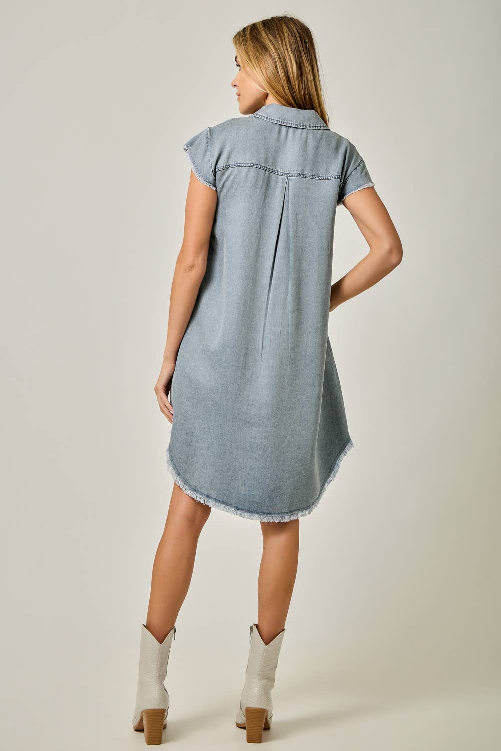 Back view Fringe Hem Tencel Shirt Dress in Light Denim Blue — button-down front, flutter cap sleeves, fringed hi-lo hem, and side pockets