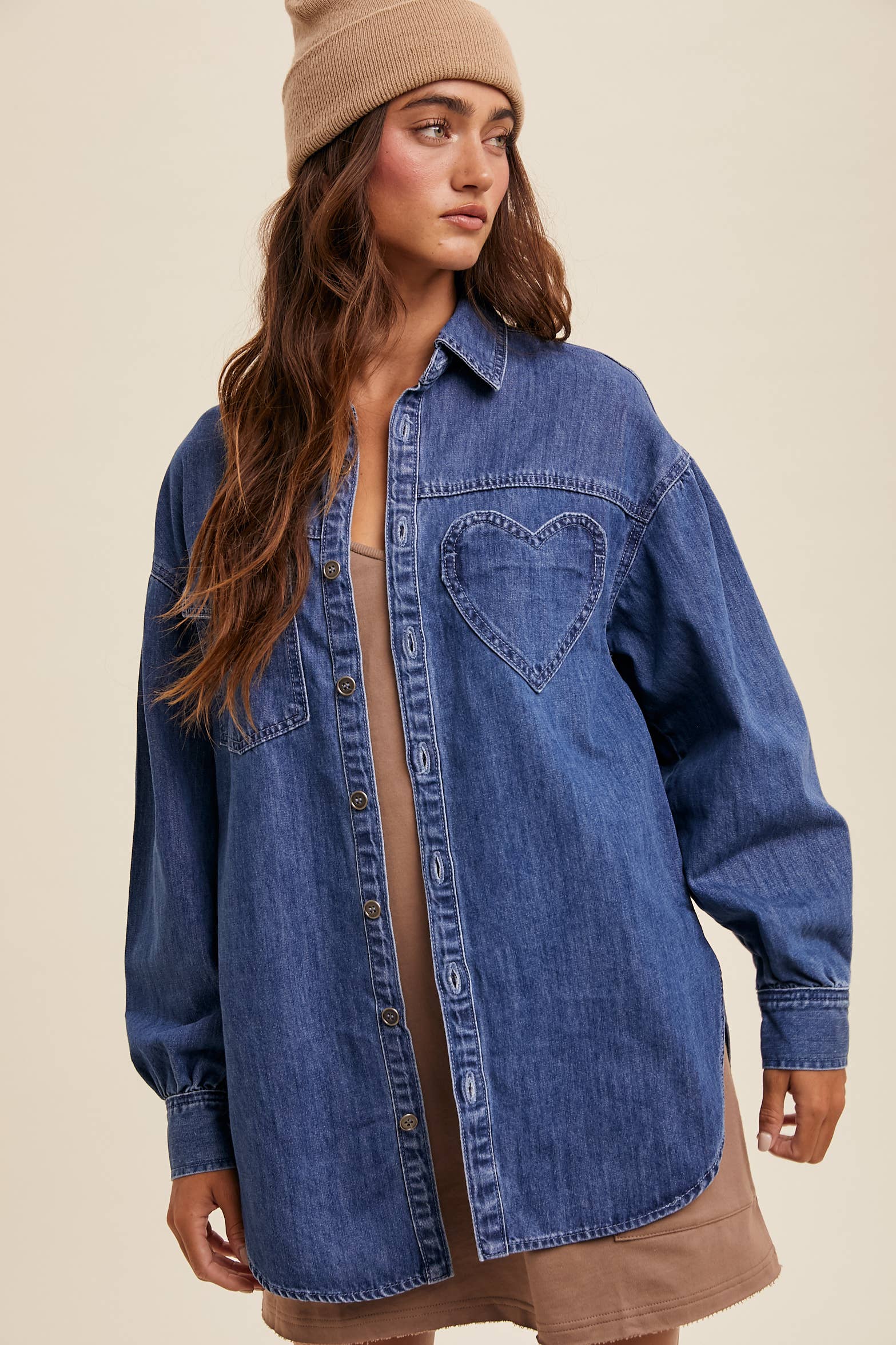 Light-wash oversized denim shacket with a heart-shaped chest pocket, button front, drop shoulders, balloon sleeves, and a curved hem.