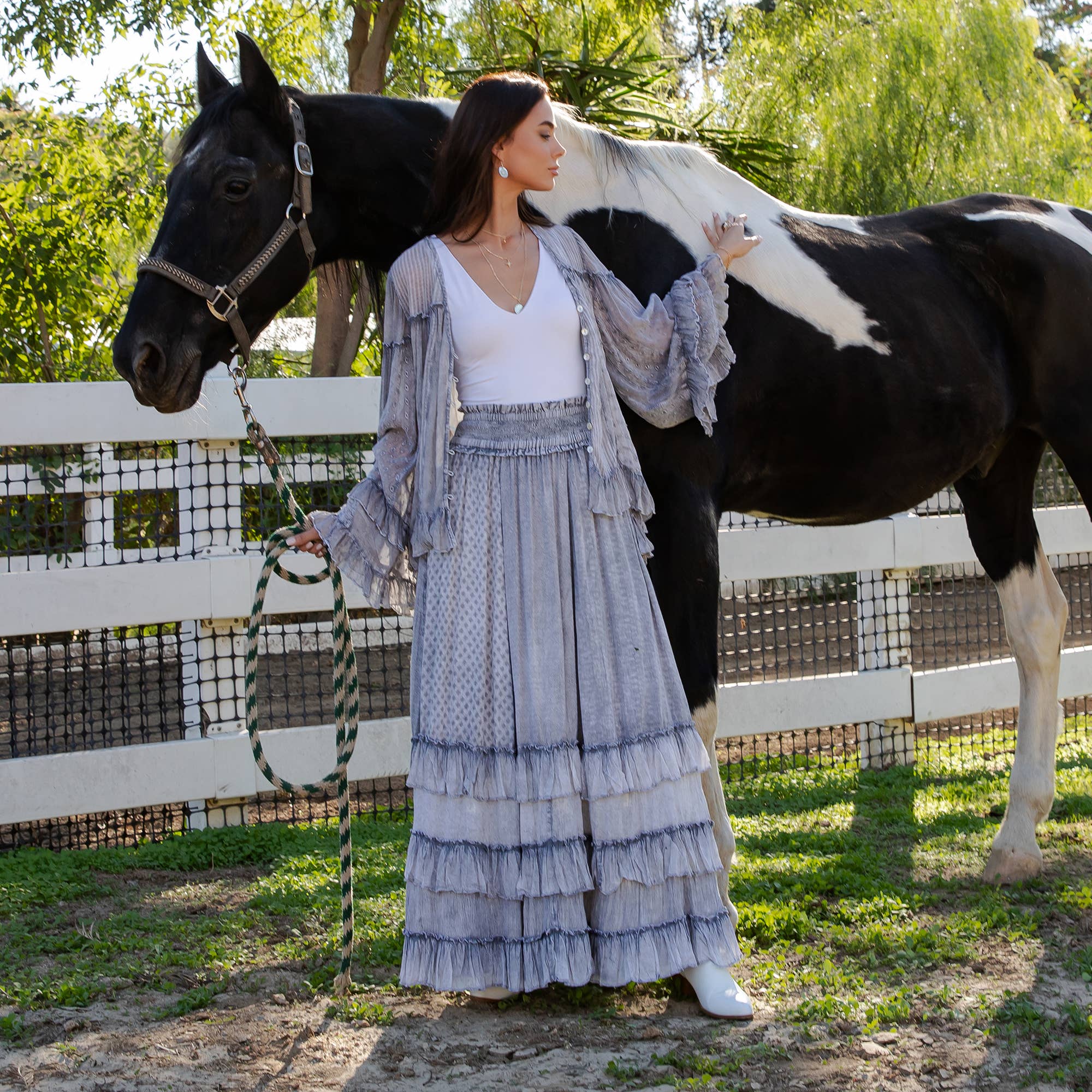 The Reverie Ruffled Tiered Maxi Skirt in Grey - side angle showing graceful movement and textured fabric