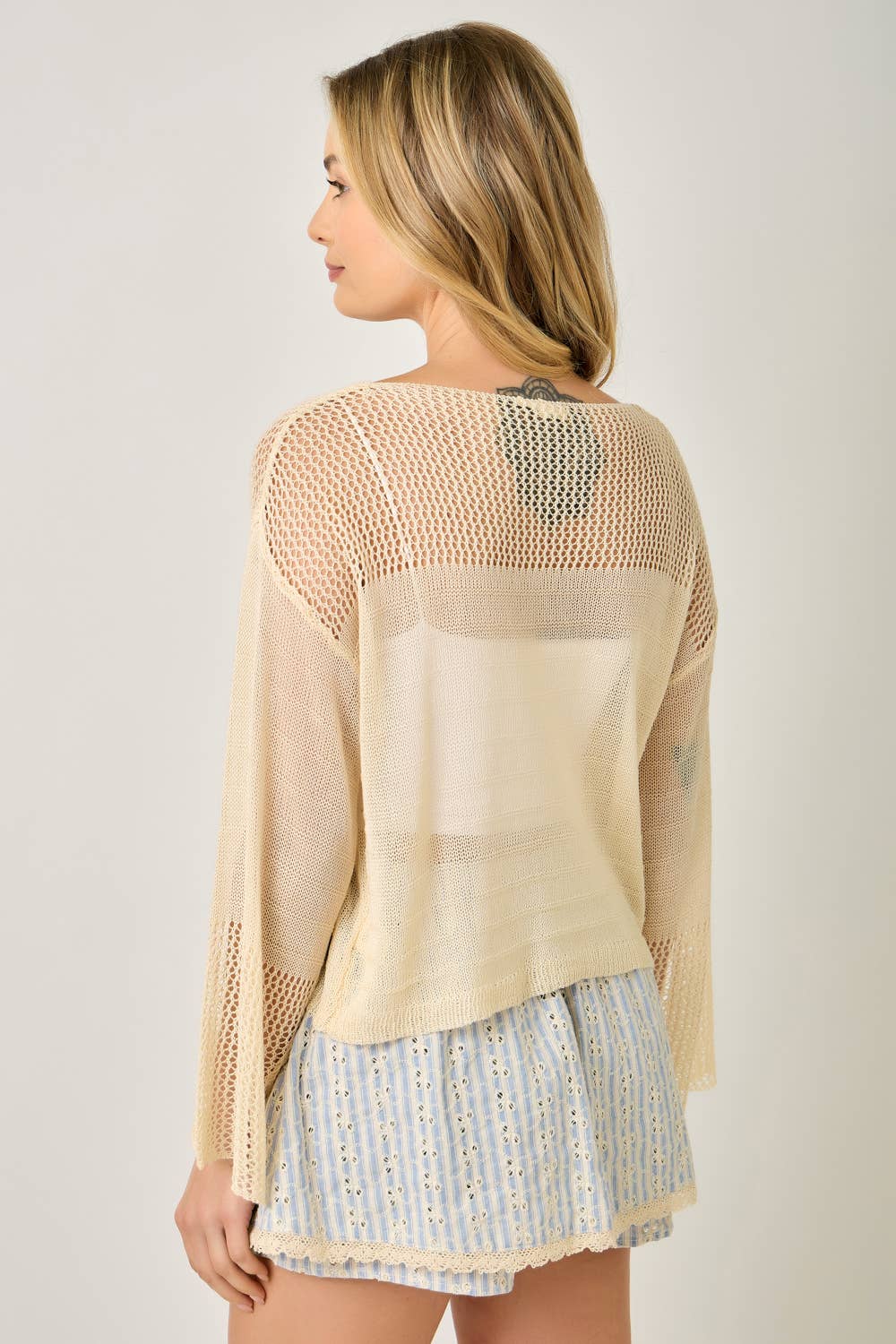 The Barely There Knit in Oatmeal - back view of relaxed sweater silhouette