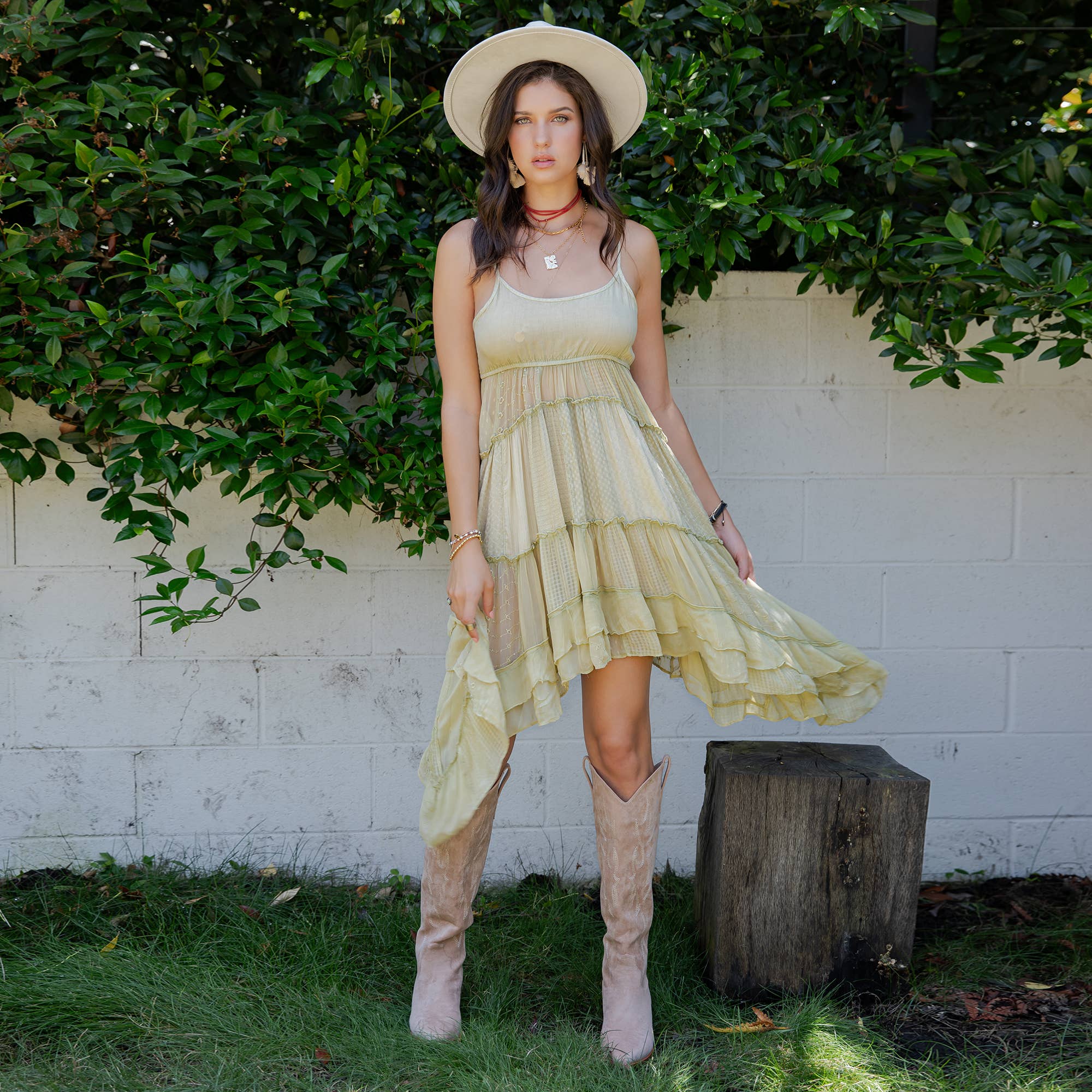 Daydream Believer dress in moss green - front view showing ruched bodice and lace-trimmed asymmetric tiers