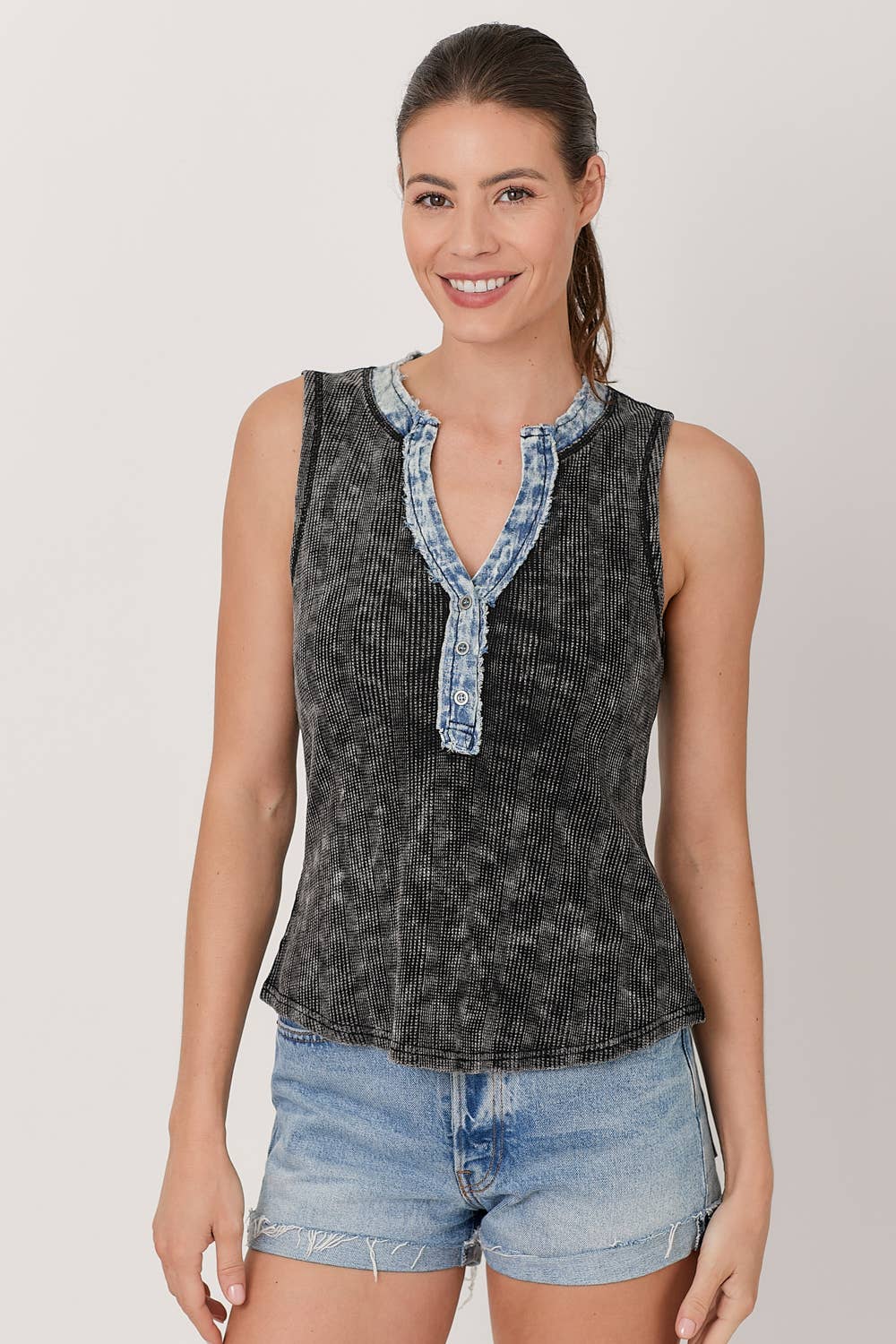 Front view of washed black and denim henley top