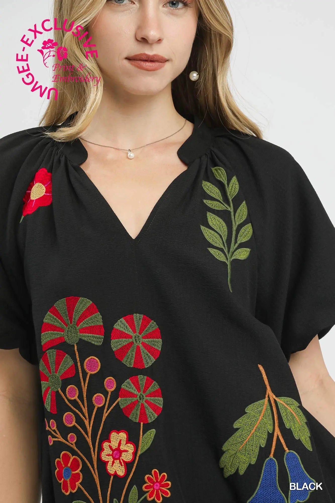 pinwheel flowers, botanical leaves, berry stems, and blue bell flowers around the neckline