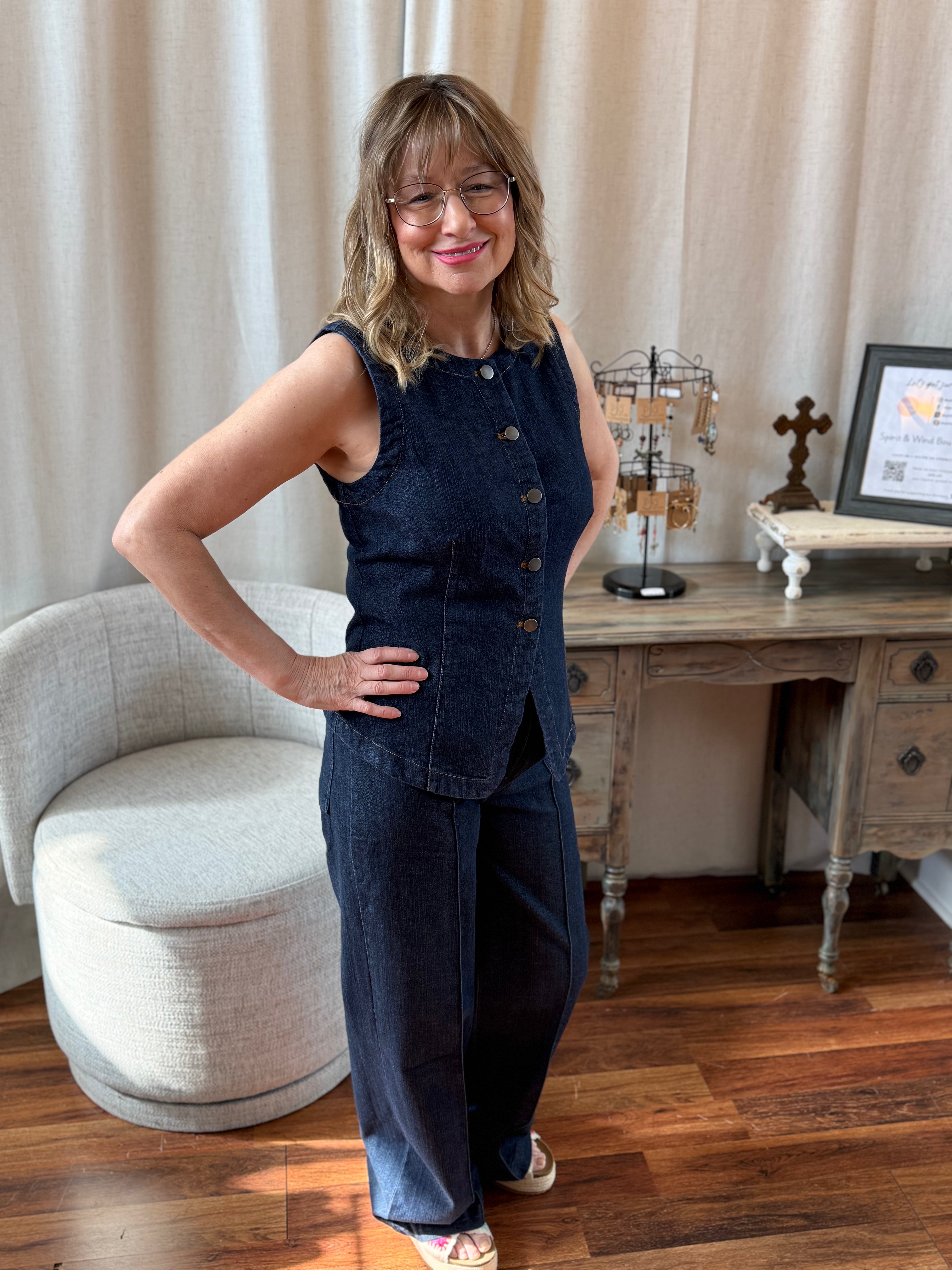 Woman in a denim vest outfit standing in Spirit and Wind Boutique