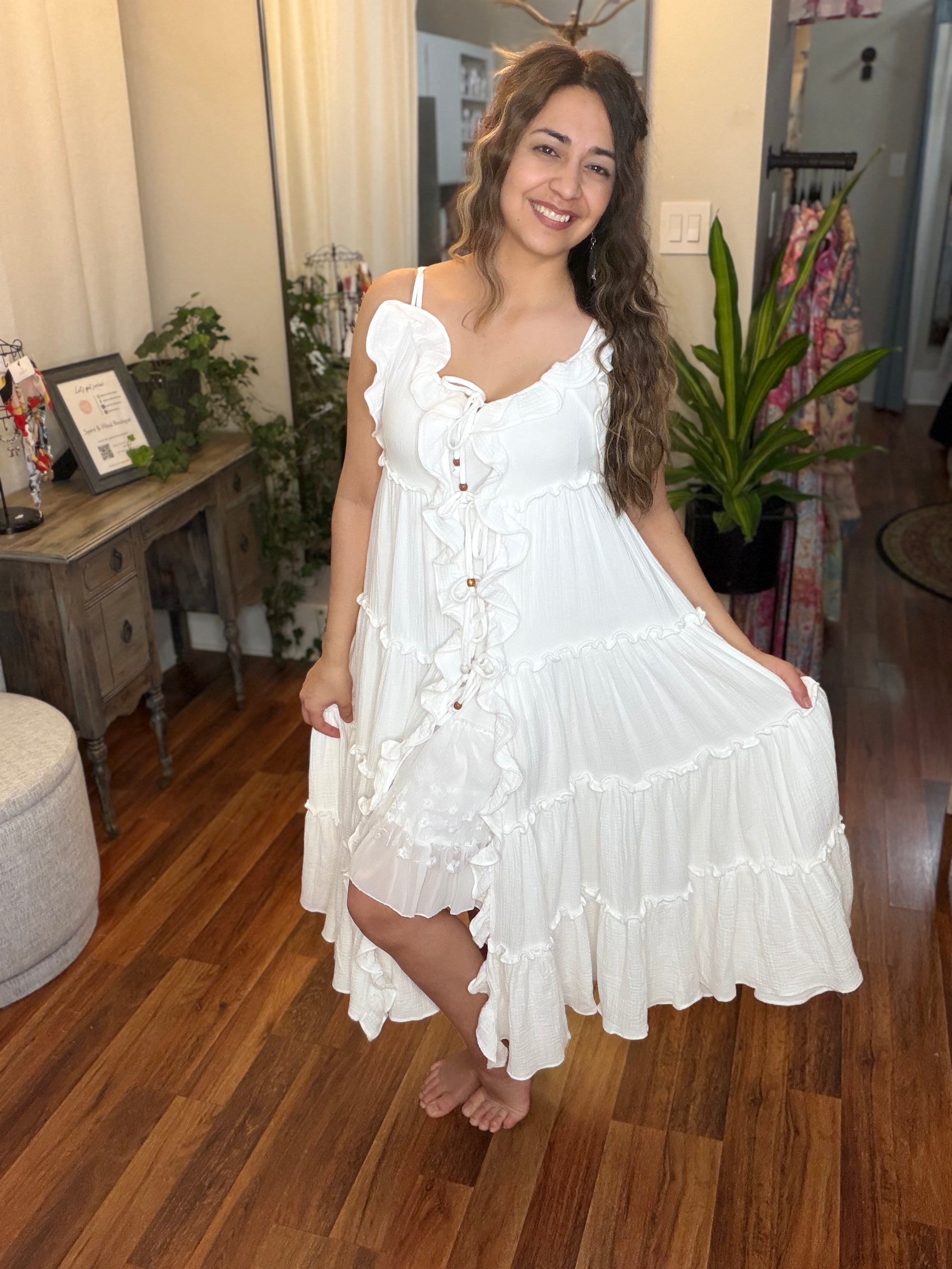 Cream ruffle cardigan dress detail - close-up of luxurious flowing fabric and cascading ruffle construction