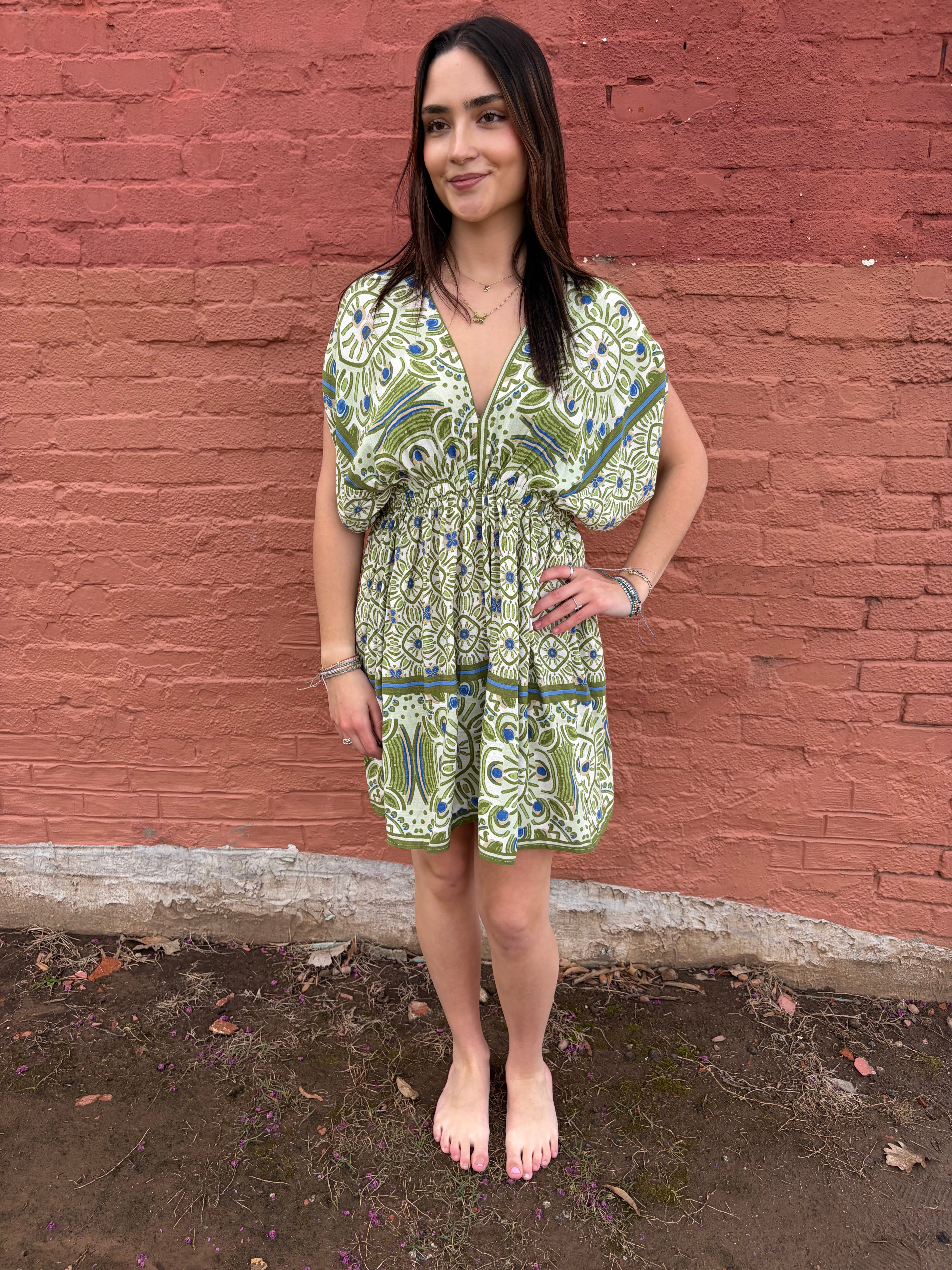 Front view of the model wearing the green Haydee Mini Dress