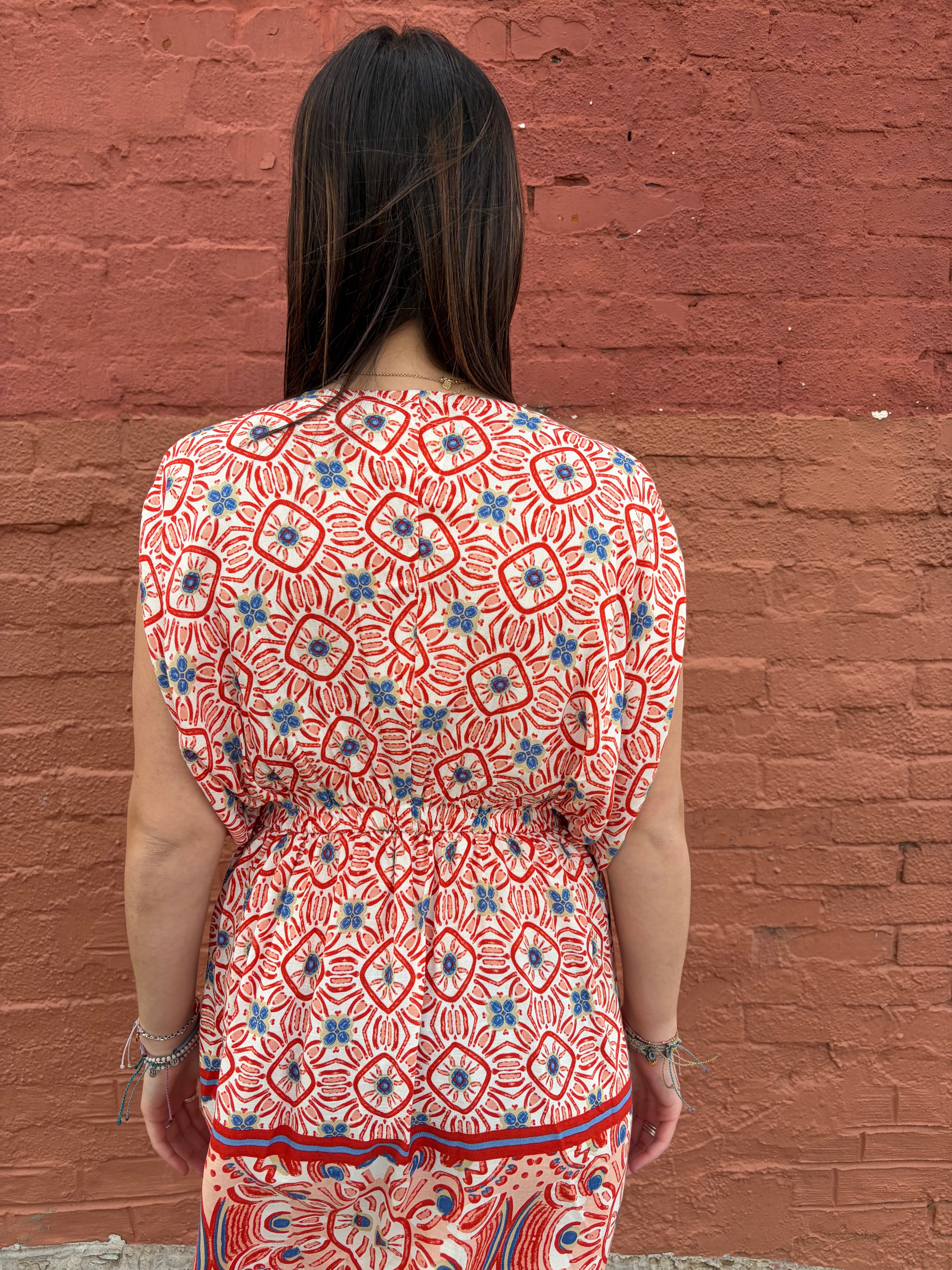 Close up of back view of model wearing the red pattern Haydee Mini Dress