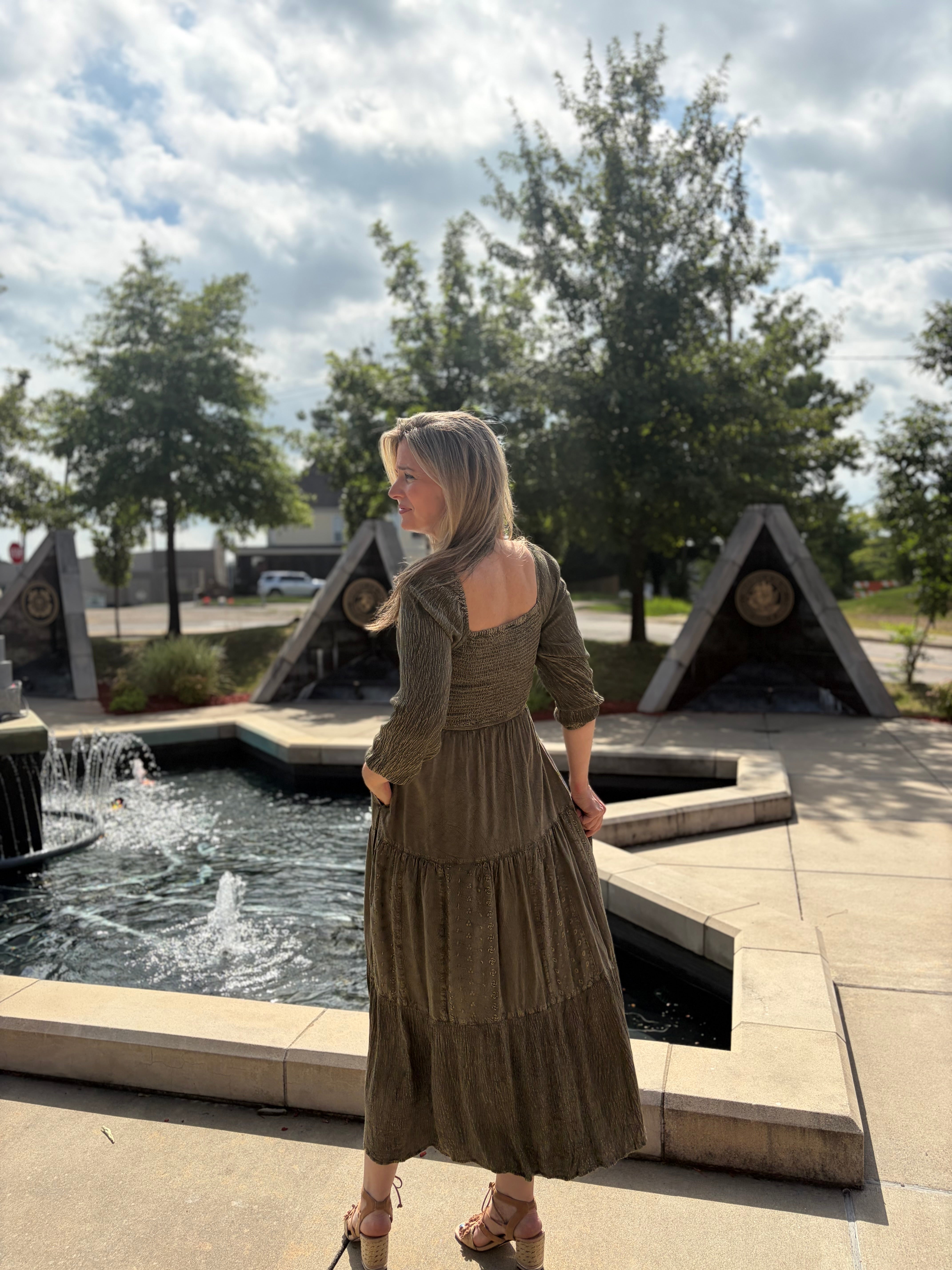 Back view of gravel embroidery delight tiered maxi dress showing square neckline, smocked back, and tiered skirt