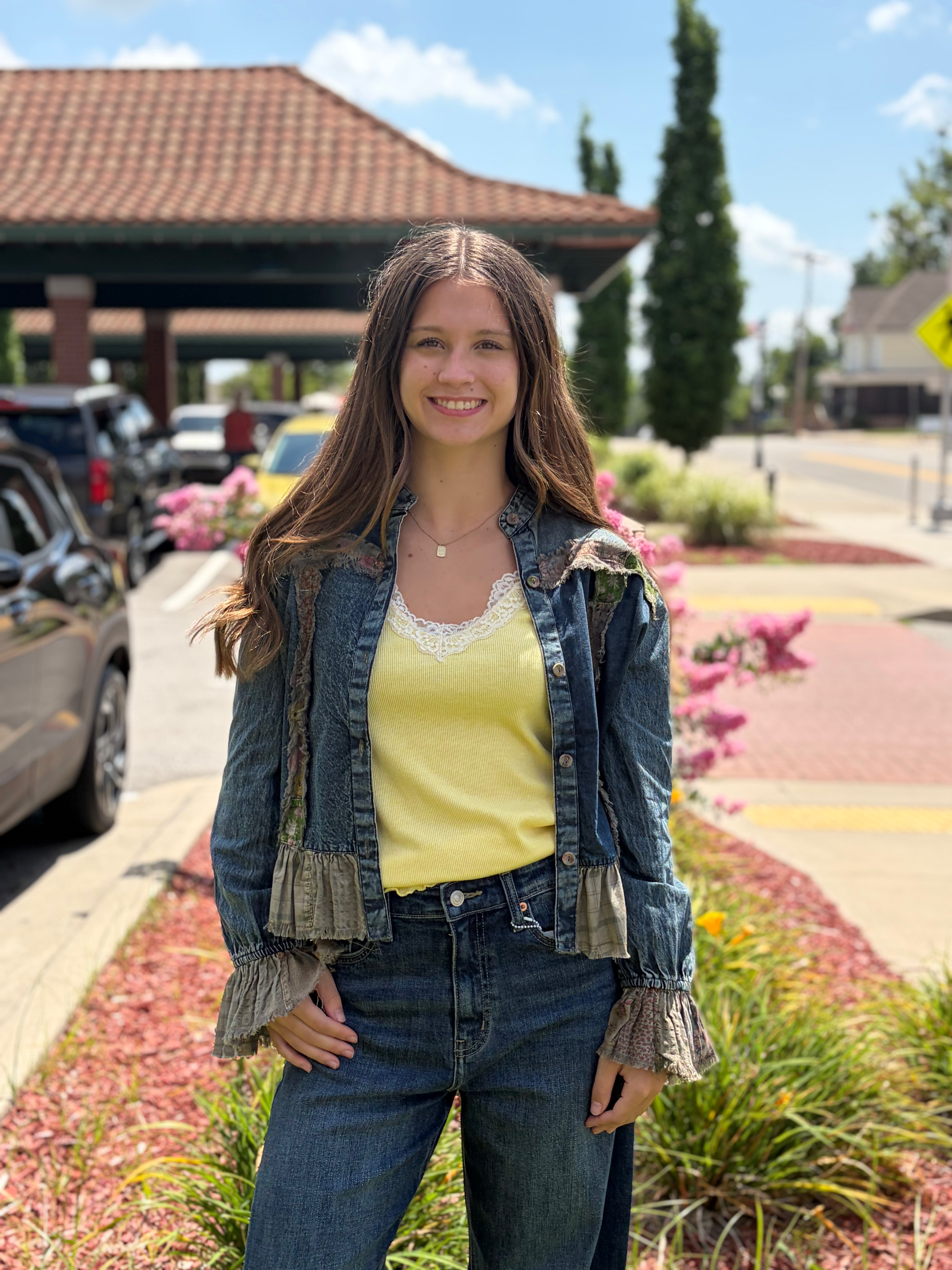 Outdoor front, smiling model, yellow cami + wide-leg jeans