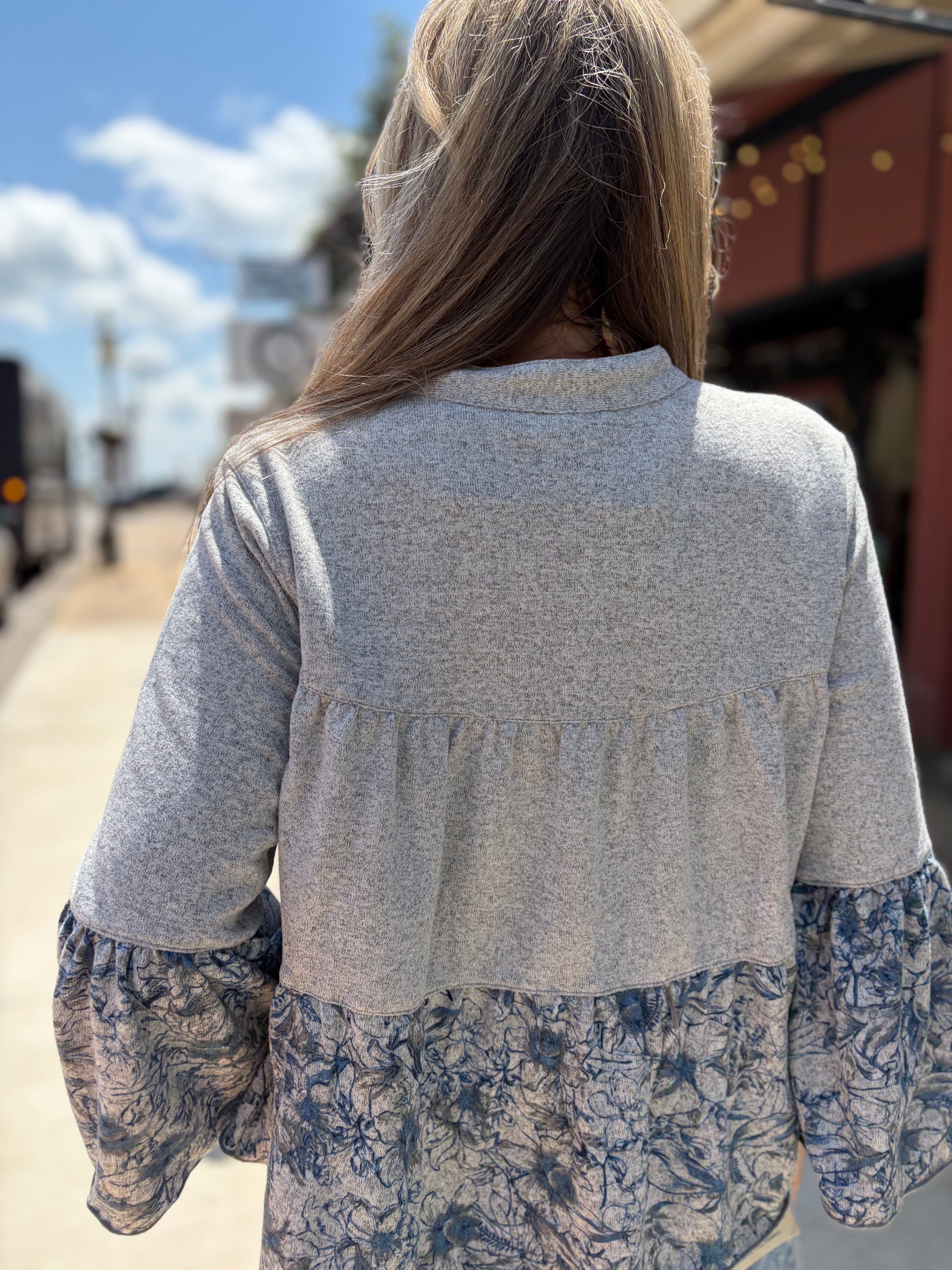 Close-up back detail, smocked yoke + gathered waist seam + floral bell sleeves