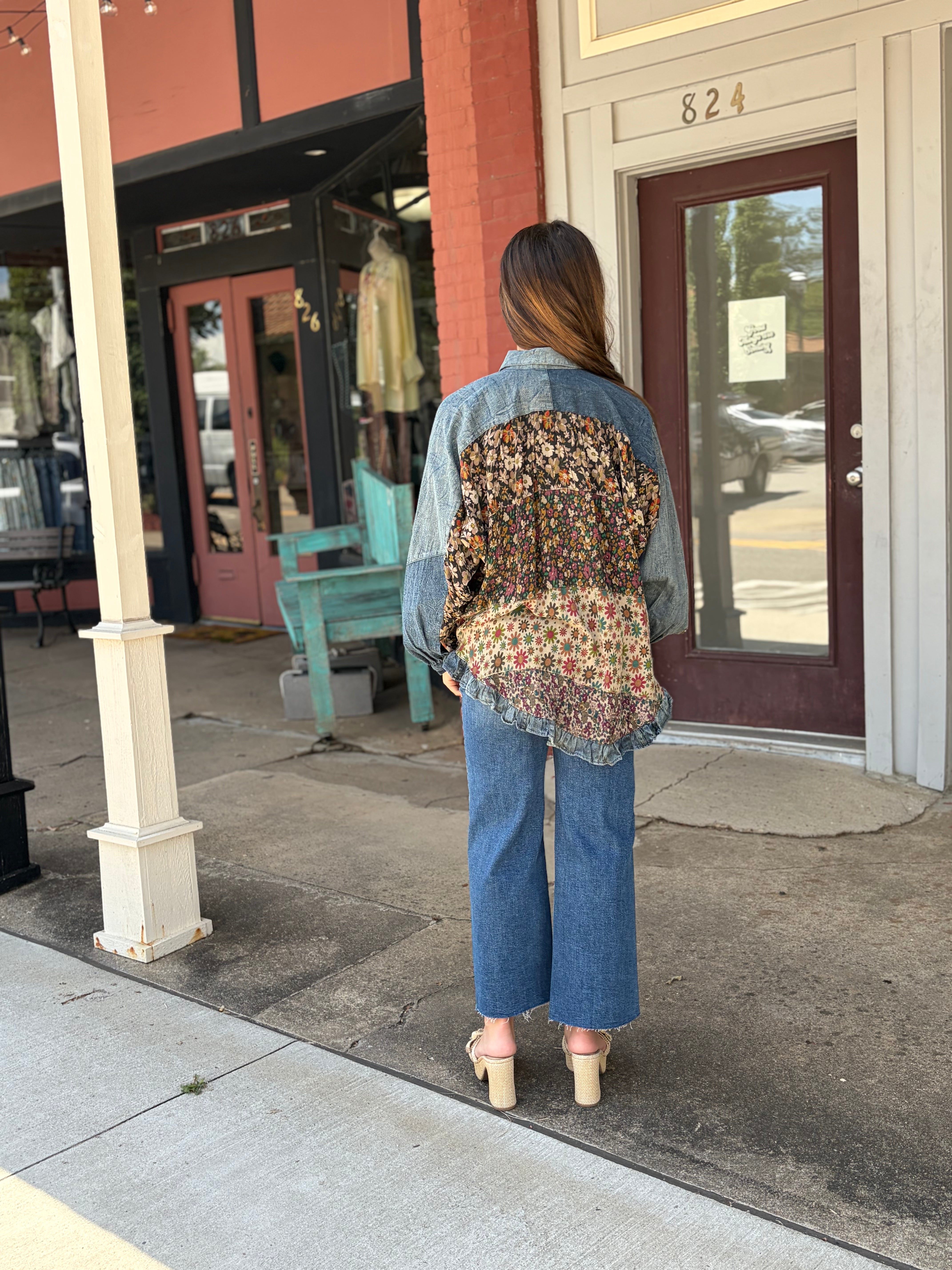 Back view, denim shoulder yoke, dark + earthy floral patchwork panels, ruffled hem