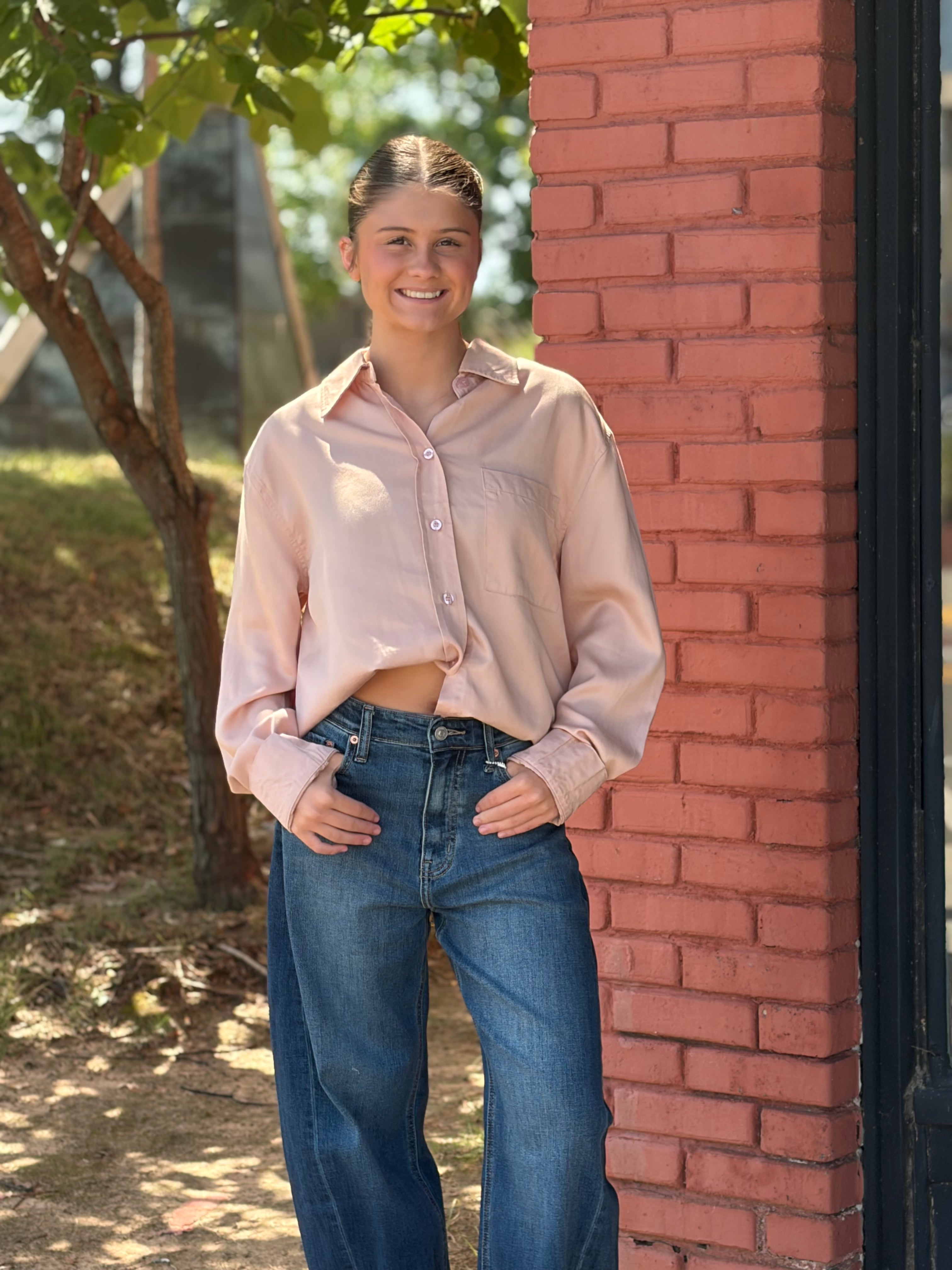 Full-length front, loose styling over wide-leg denim