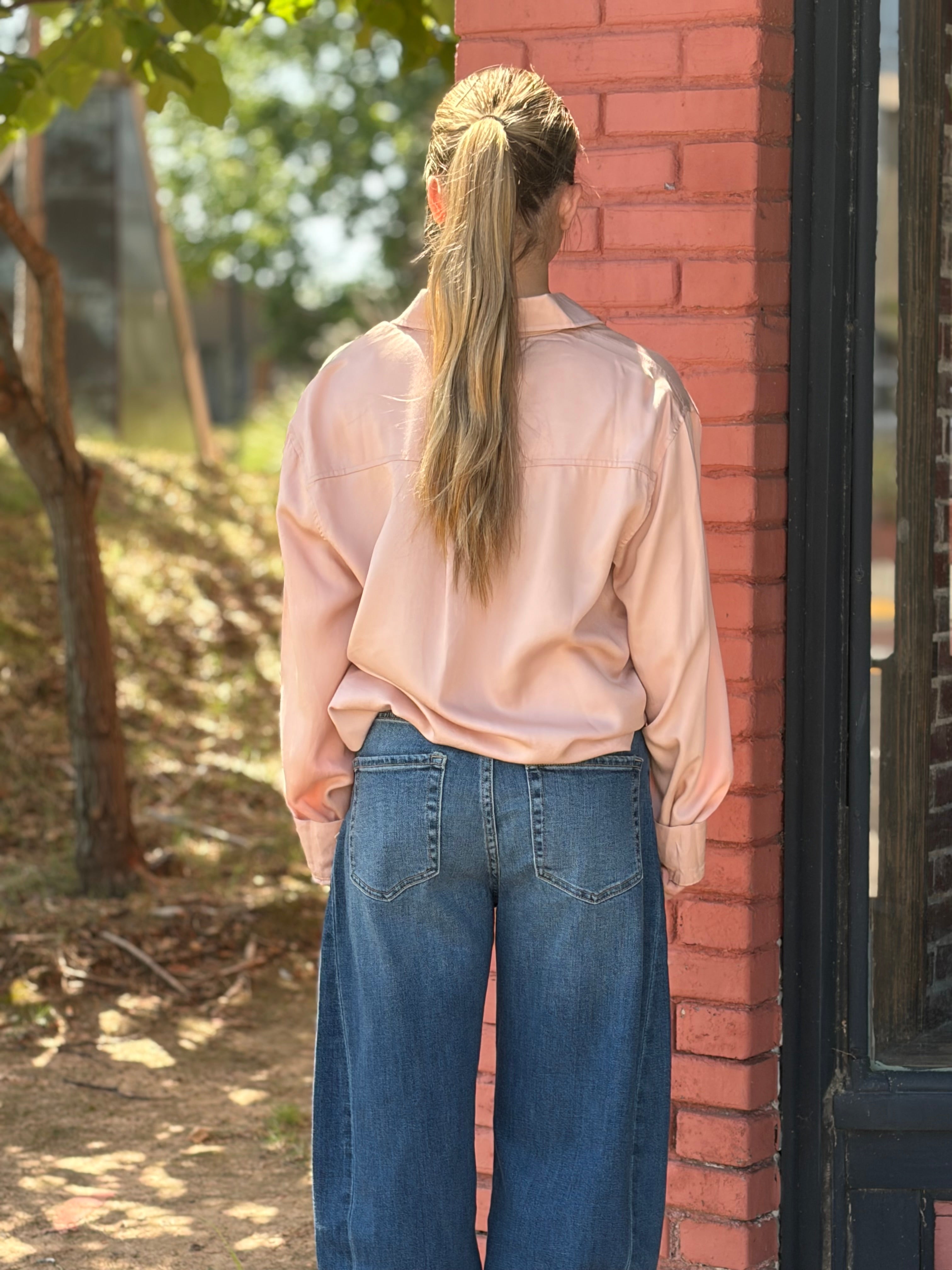 Close-up detail of chest pocket, buttons, and cuffed sleeves