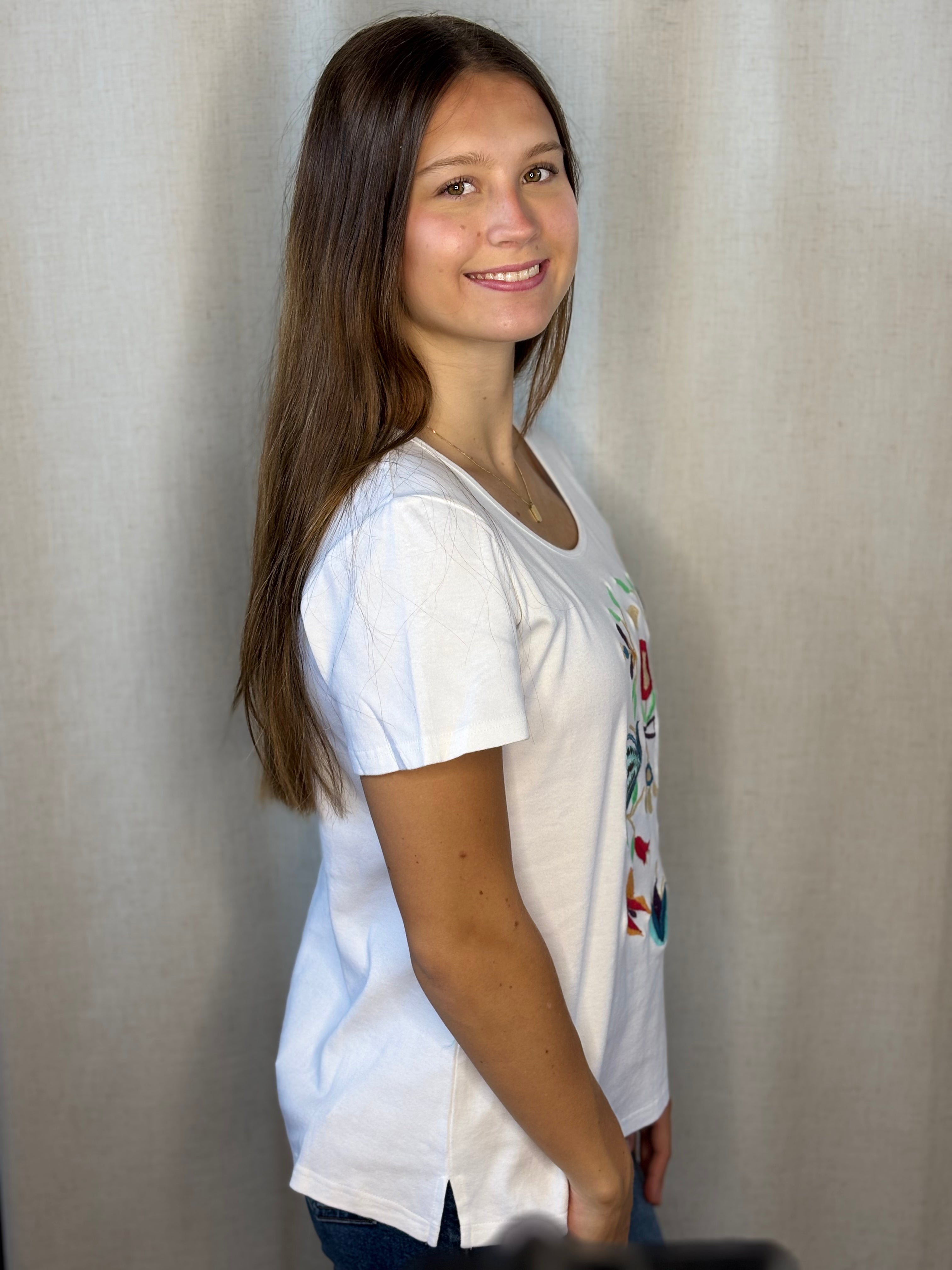 Anü Birds & Butterflies Embroidered Tee in white — side profile showing relaxed fit and short sleeve silhouette