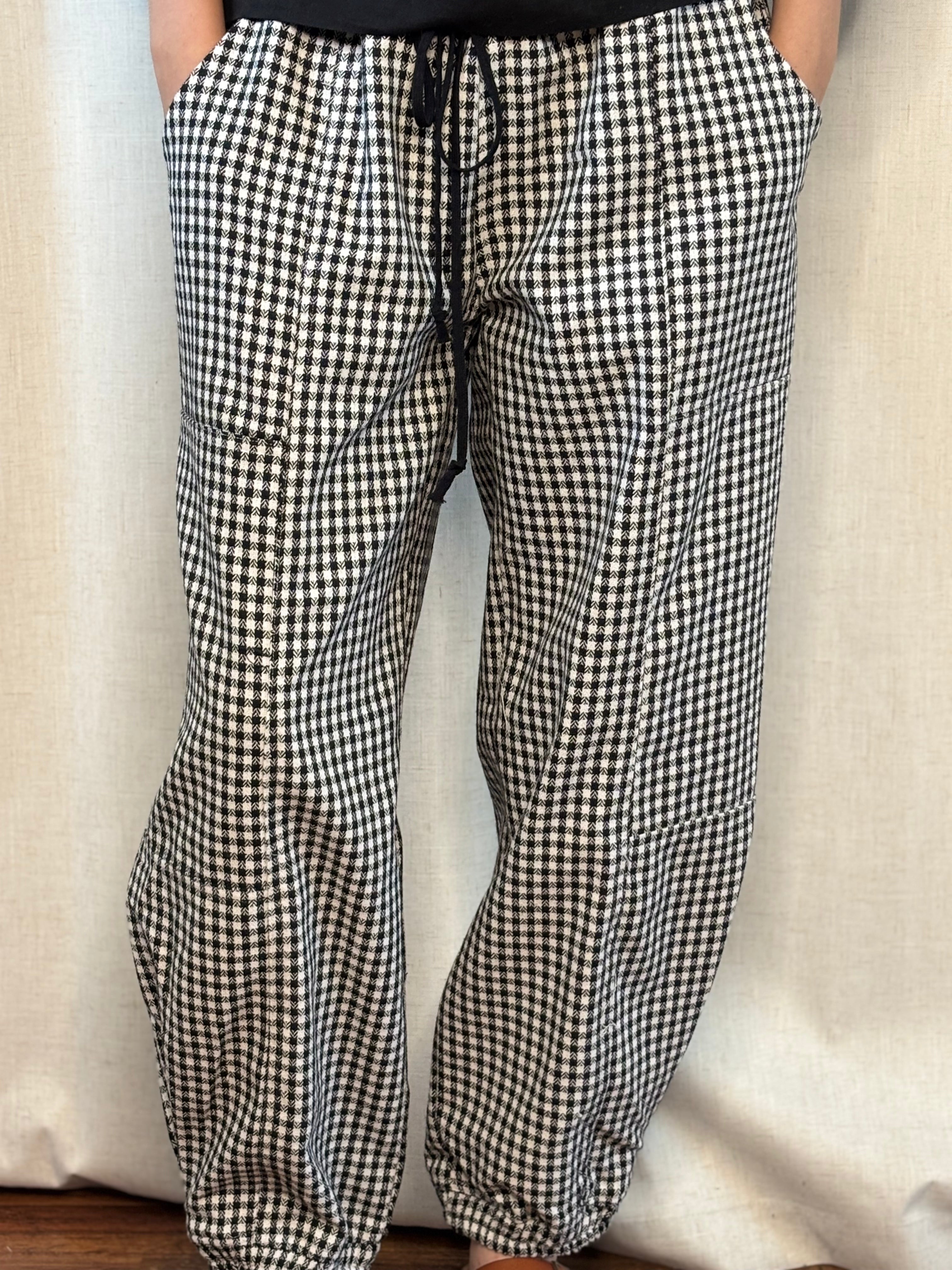 Front close-up of NOABOA Mini Plaid Cuffed Barrel Pants showing drawstring waist, side patch pocket, and black and white mini plaid fabric detail