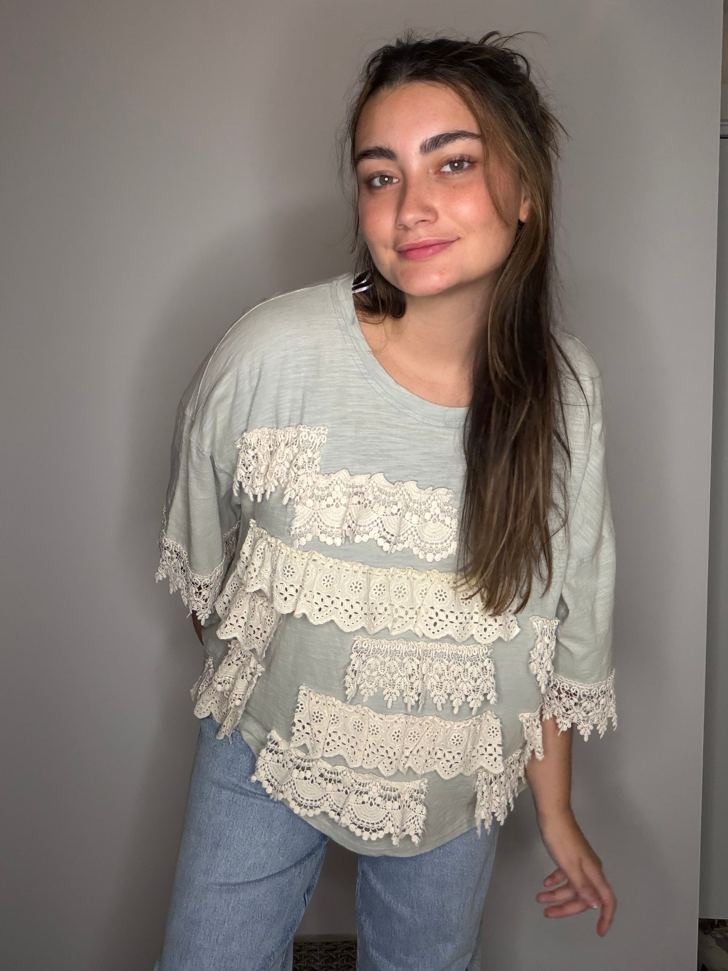Front facing: layered lace ruffle detail across chest and half sleeves