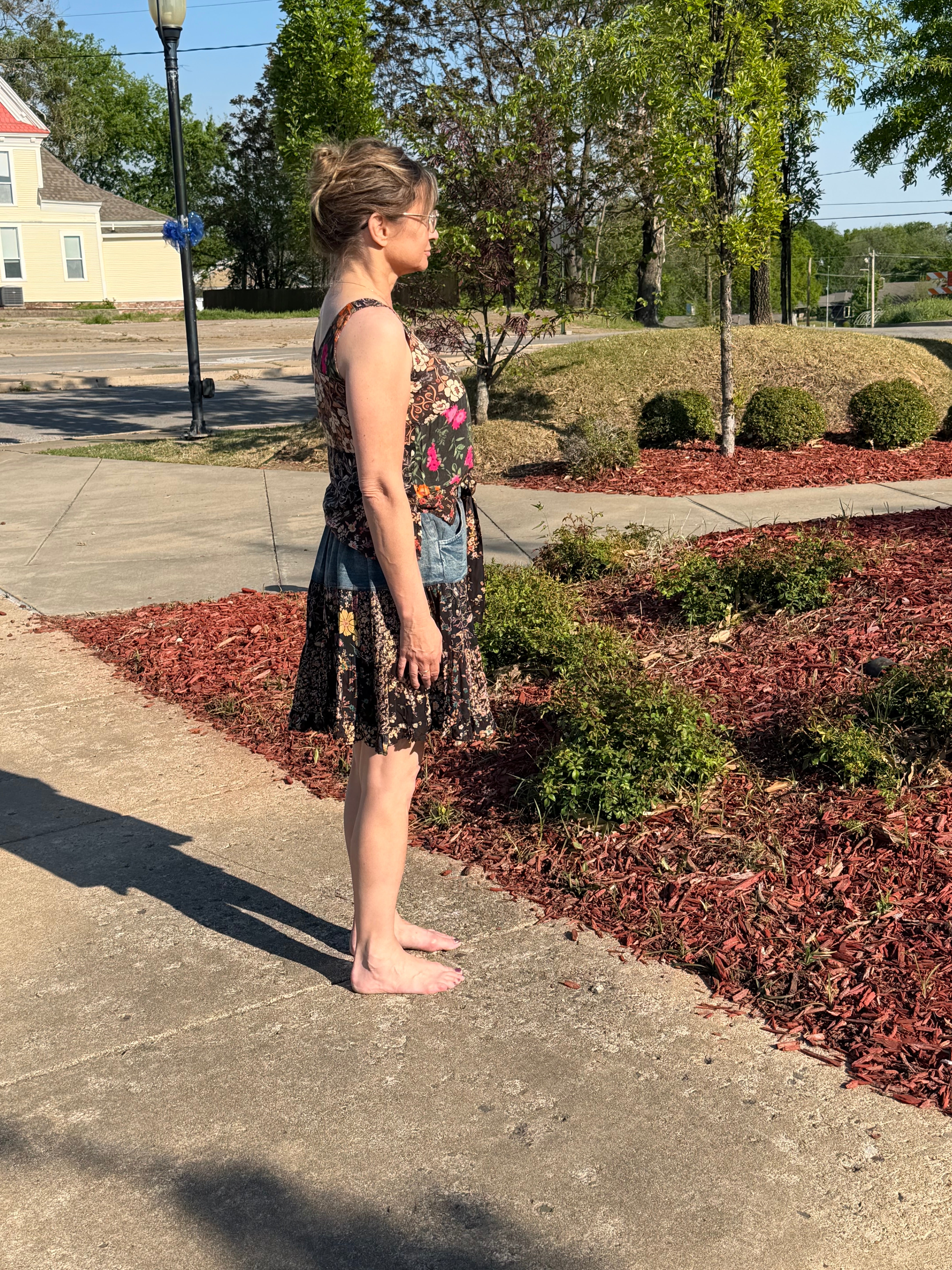 Side view of Boho Patchwork Denim Set – Sleeveless floral patchwork denim tank that has rayon print mini skirt with pockets | Spirit & Wind Boutique