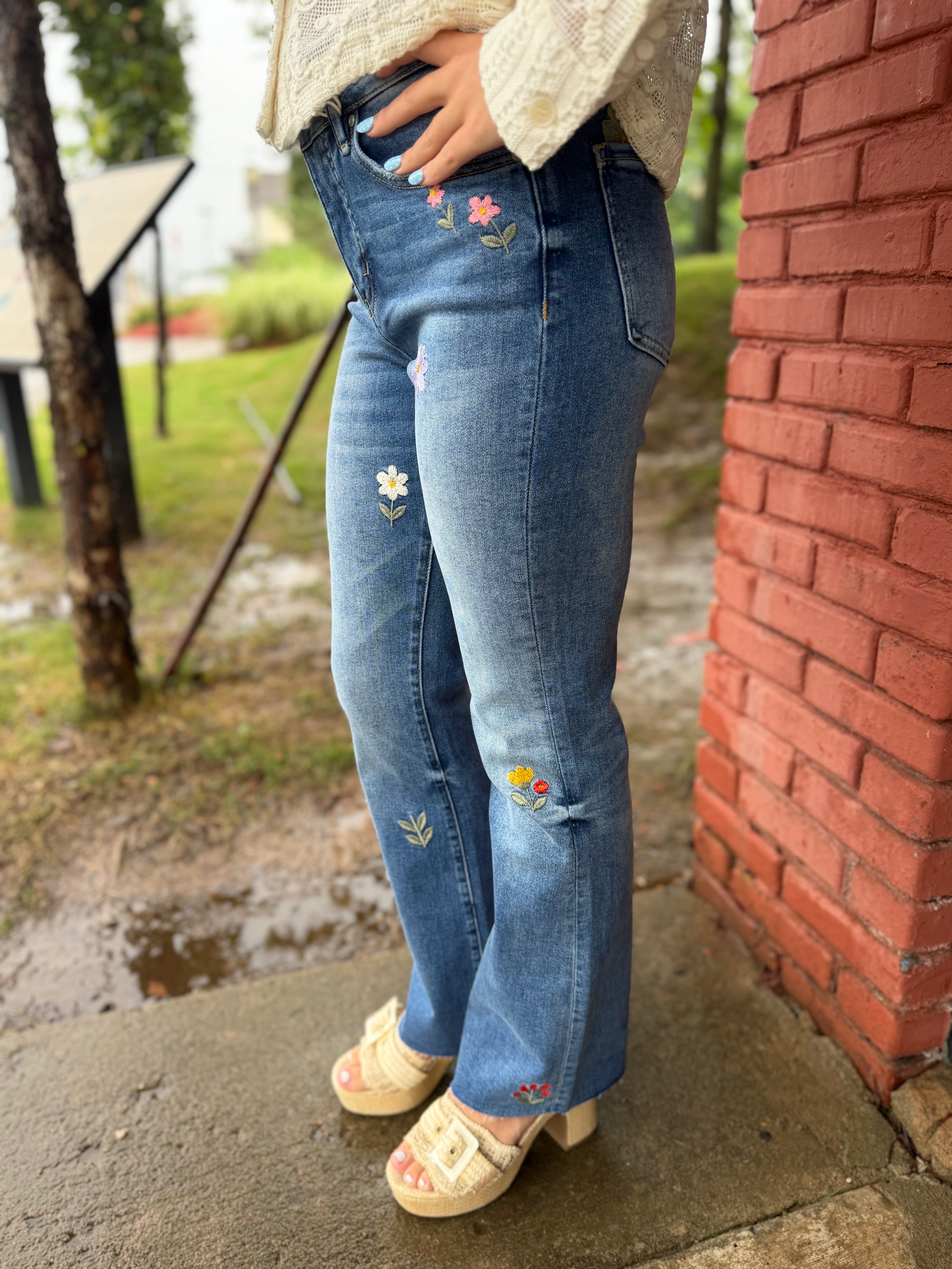 Side view of Flower Embroidered Mid Rise Bootcut Jeans in Medium Blue