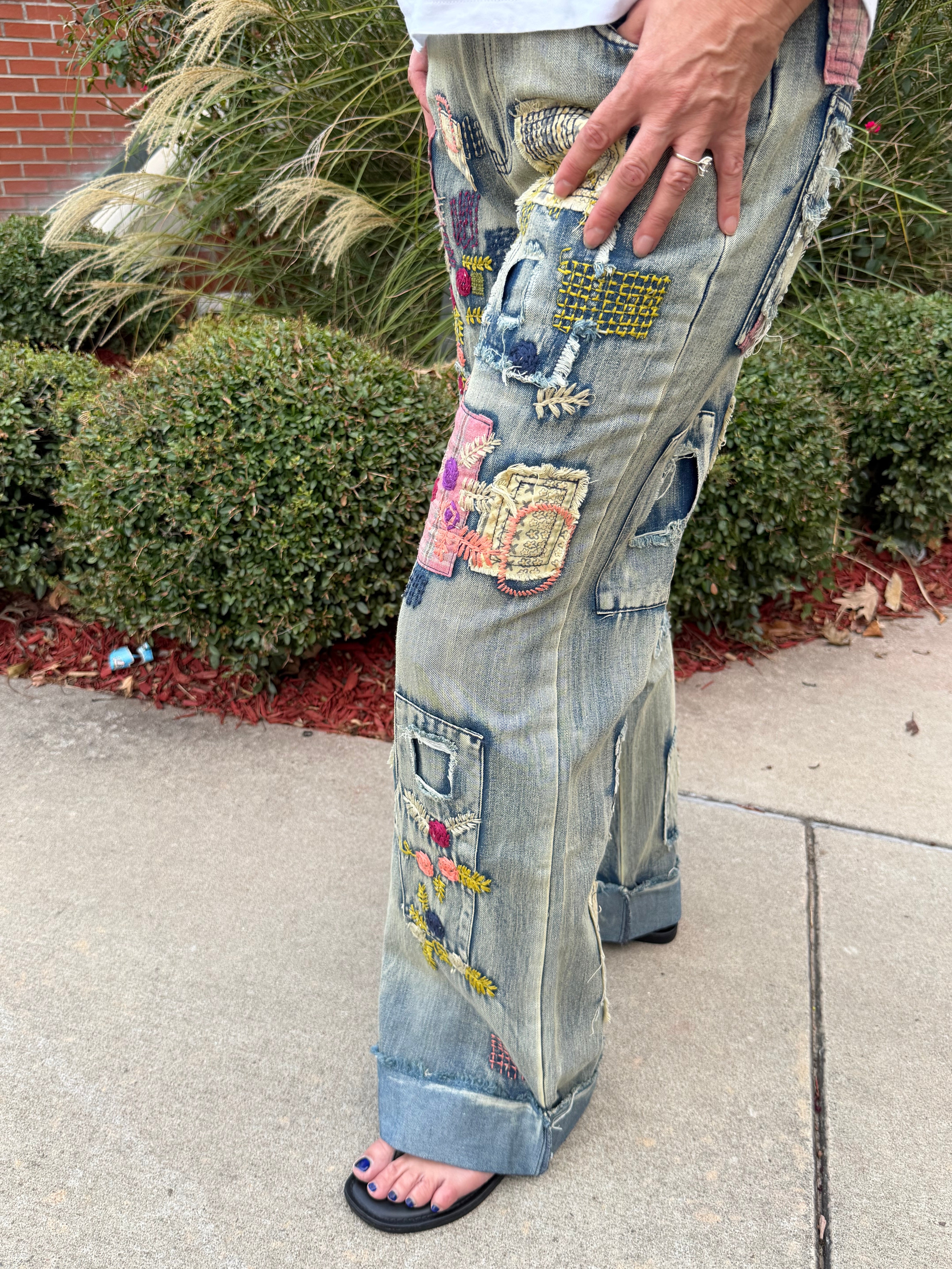 Close-up front detail of Blue Velvet BP10496KB artisan patchwork embroidered wide leg denim jeans showing mixed-fabric patches and embroidery