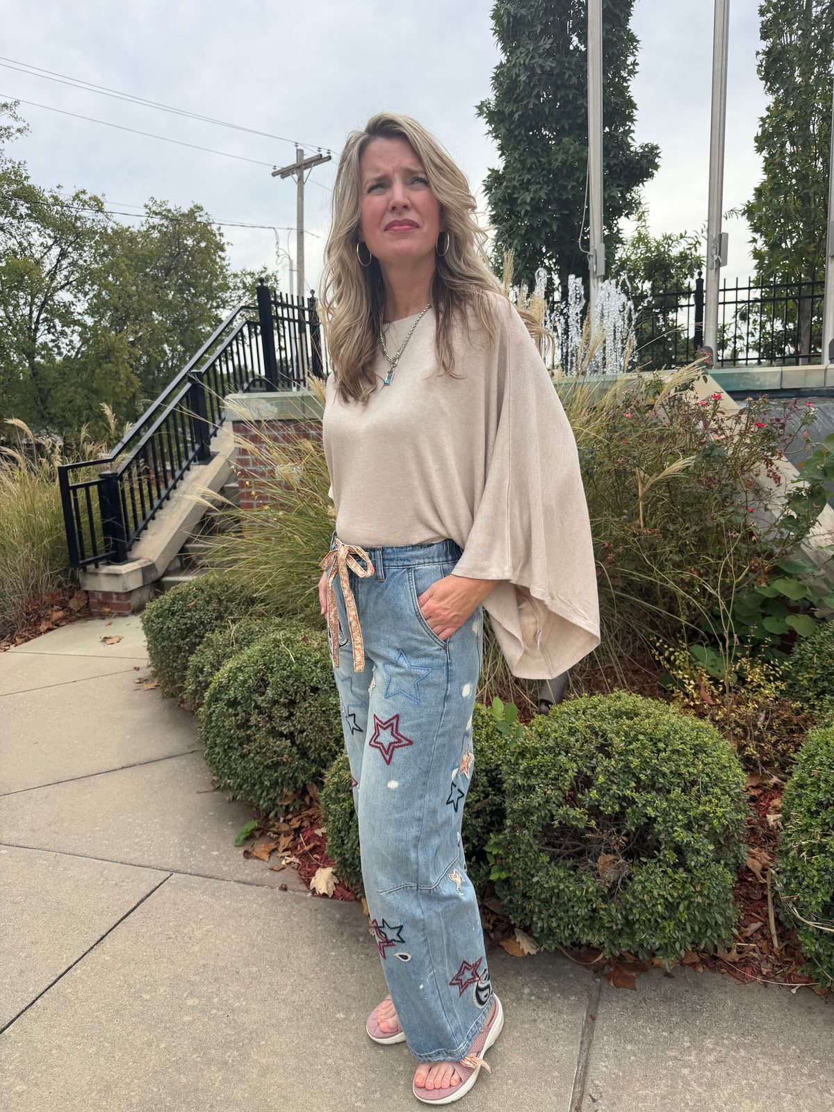 Embroidered denim pants with mixed star and paisley designs