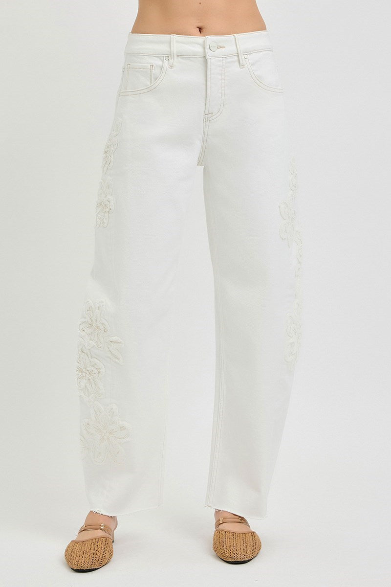 White jeans with slight distressing on a white background