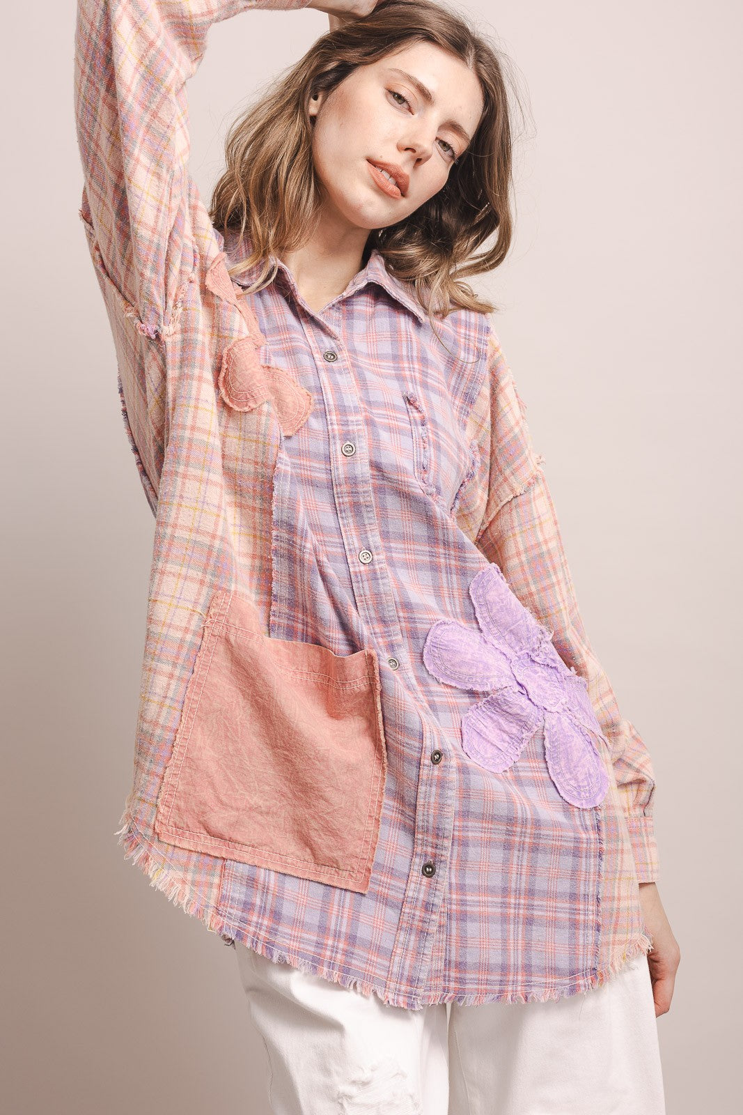 Three-quarter view, arm raised, flower appliqués, patch pocket, frayed hem