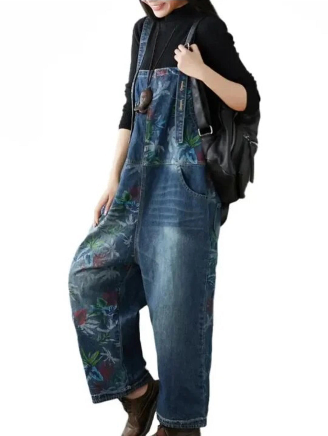 Side view wearing floral-patterned denim overalls on a white background
