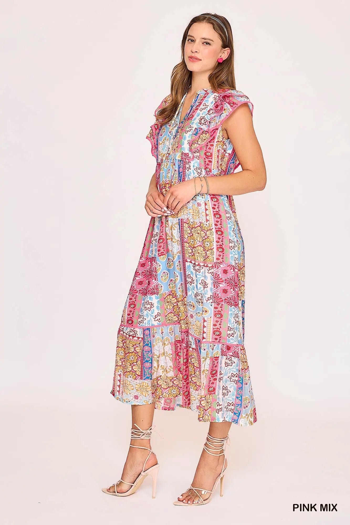 Woman wearing a colorful patchwork dress on a white background