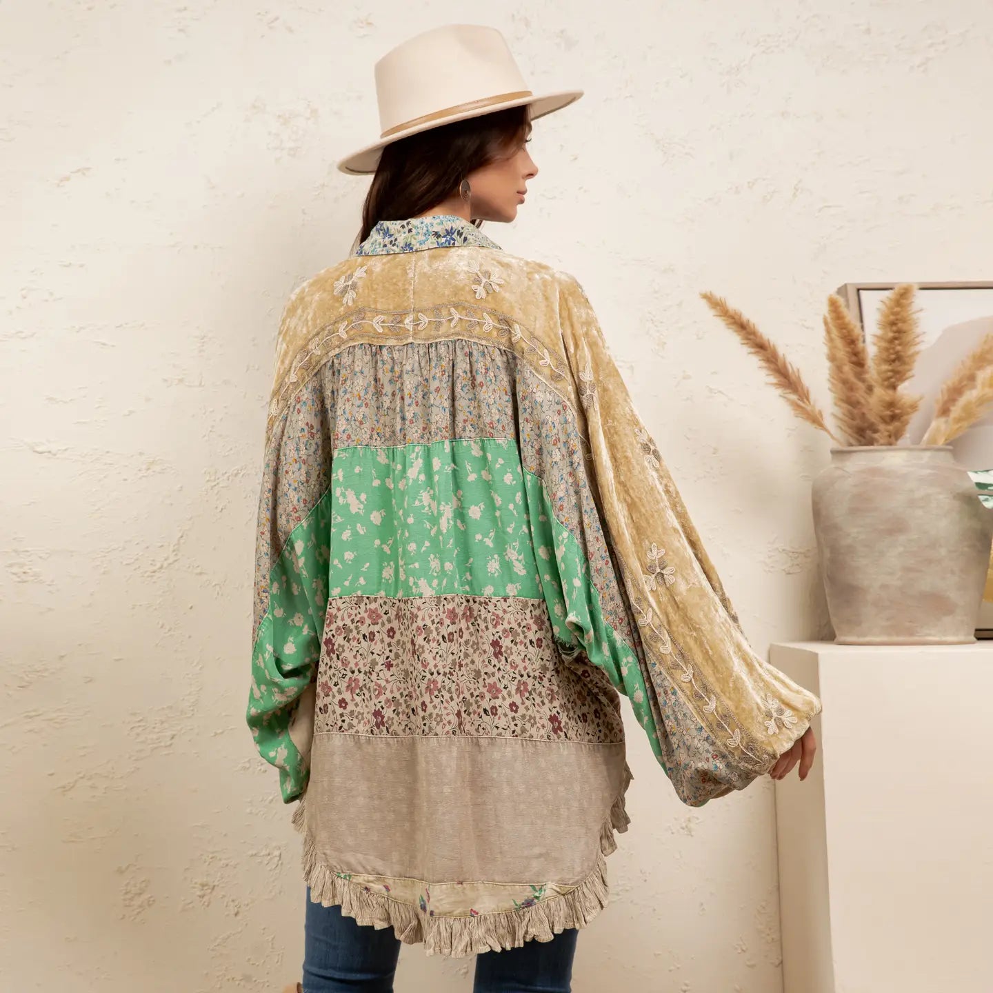 back view Vintage mixed print patchwork bat sleeve top in earthy taupe and floral — velvet panels, balloon sleeves with tassel trim, ruffle hem, boho-luxe style by Young Threads