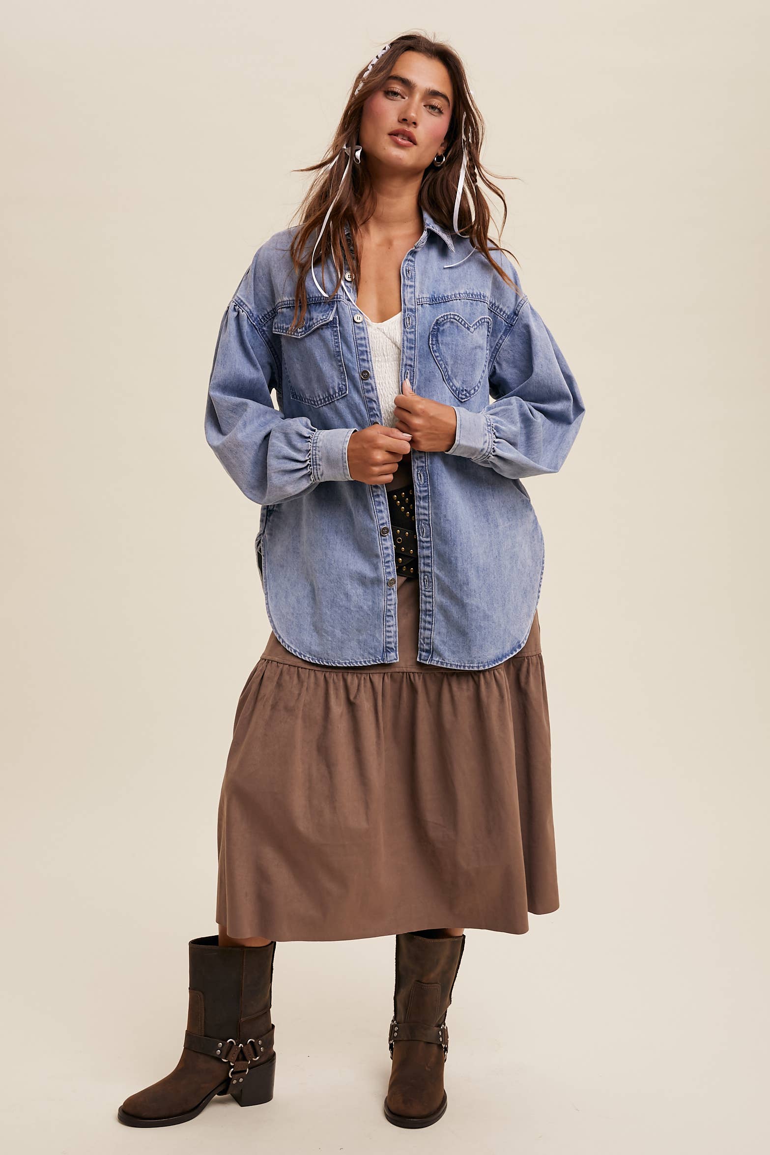 Light-wash oversized denim shacket with a heart-shaped chest pocket, button front, drop shoulders, balloon sleeves, and a curved hem.