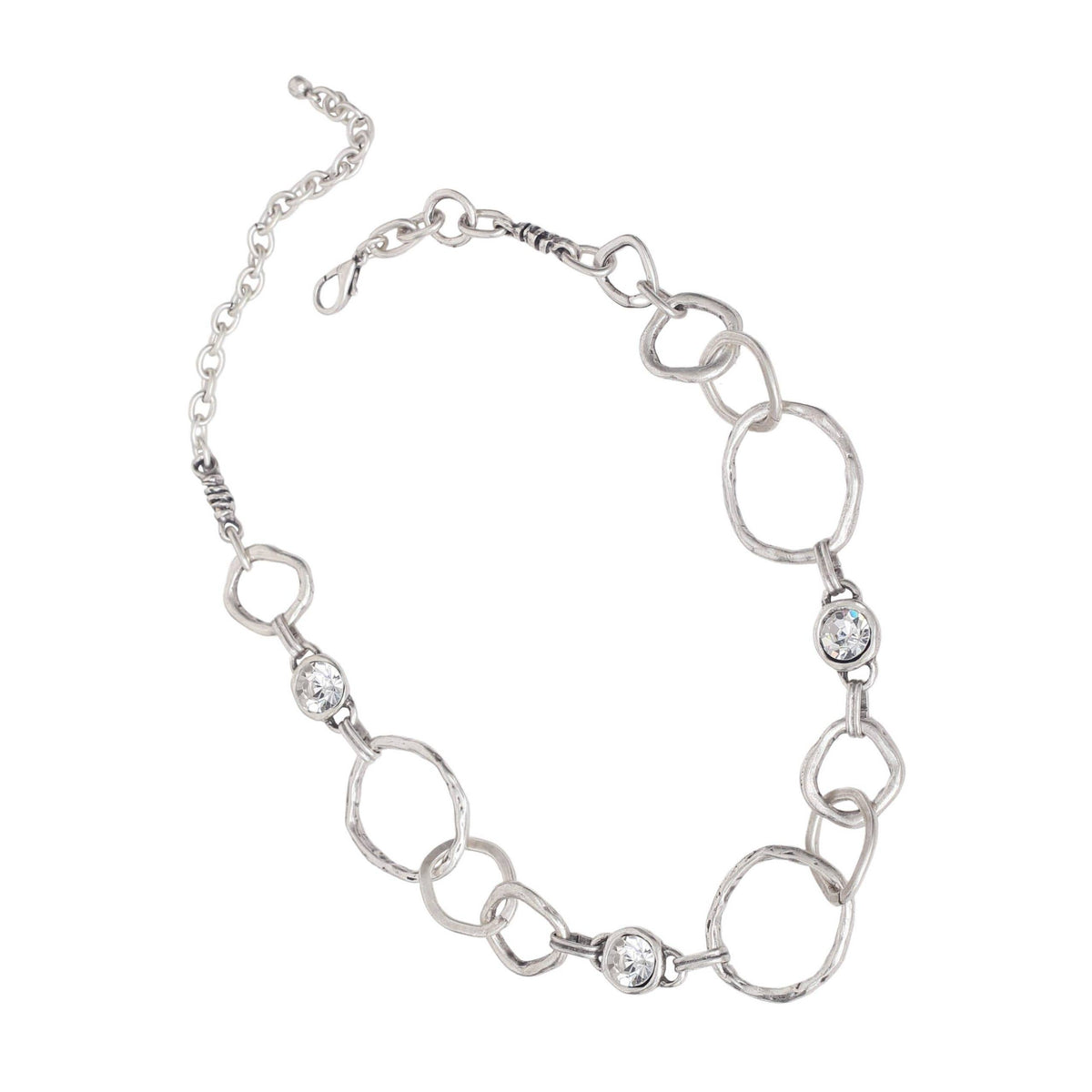A silver-toned link bracelet featuring textured oval links, smooth circular links, and three clear rhinestone accents, displayed on a solid white background.