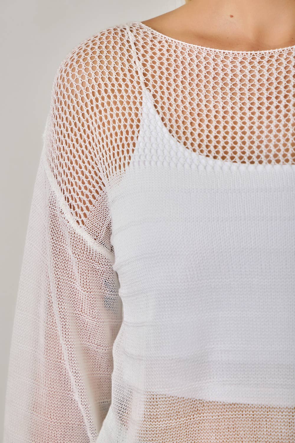 The Barely There Knit in Ivory - detail shot of fishnet sleeve construction