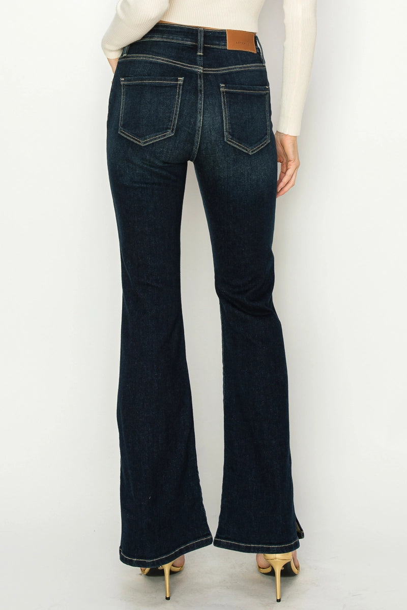 Back view—Artemis Vintage Shadow Canyon Flare dark indigo flare jeans with contrast stitching and back pockets.
