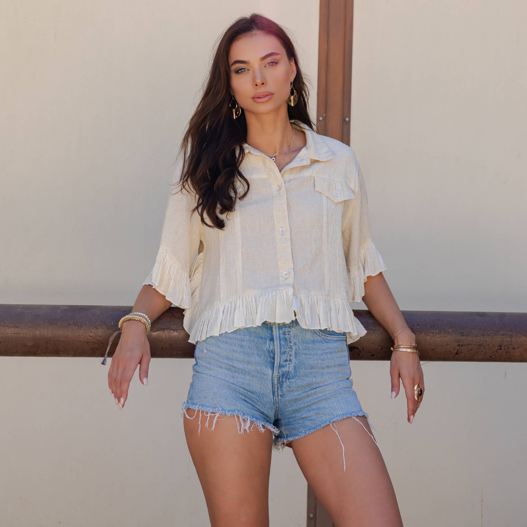 The Rebel Cropped Denim Shirt - front view showing button-down design and ruffled hem detail