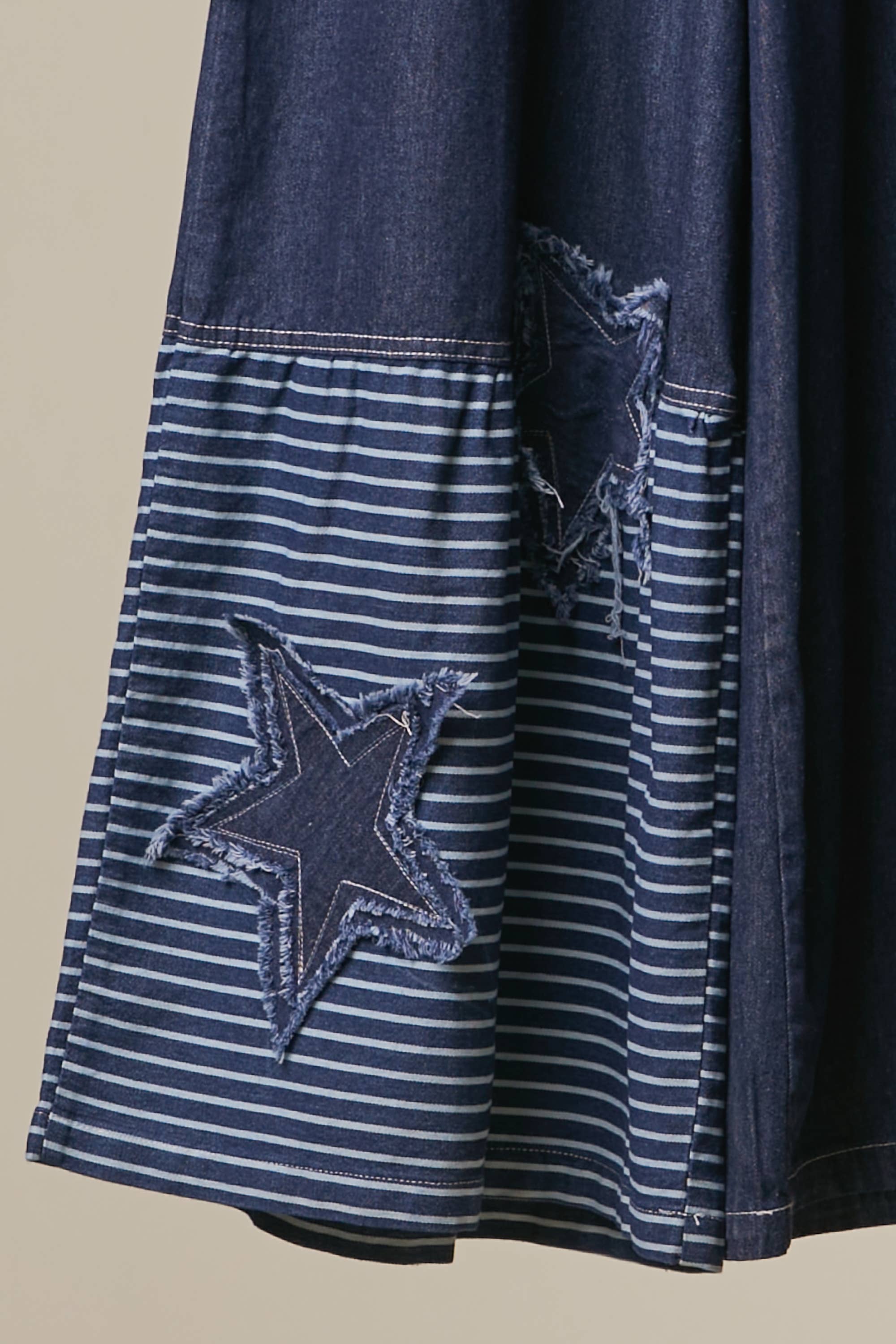 Close up bottom view of star patch Blue Star Wide Leg Patchwork Denim Pants in dark blue wash with frayed star patches, elastic waist and drawstring — boho wide leg style by Mello