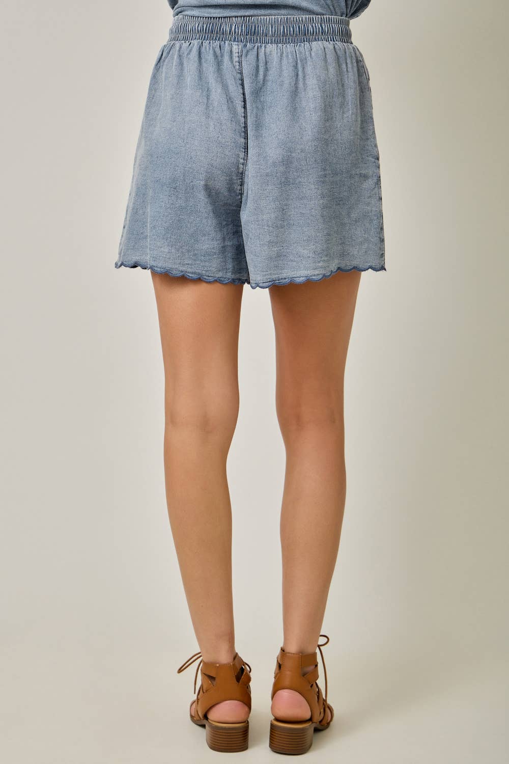 Back view Eyelet Embroidered Washed Tencel Shorts in Dark Denim — scallop hem, drawstring waist, and boho eyelet detail