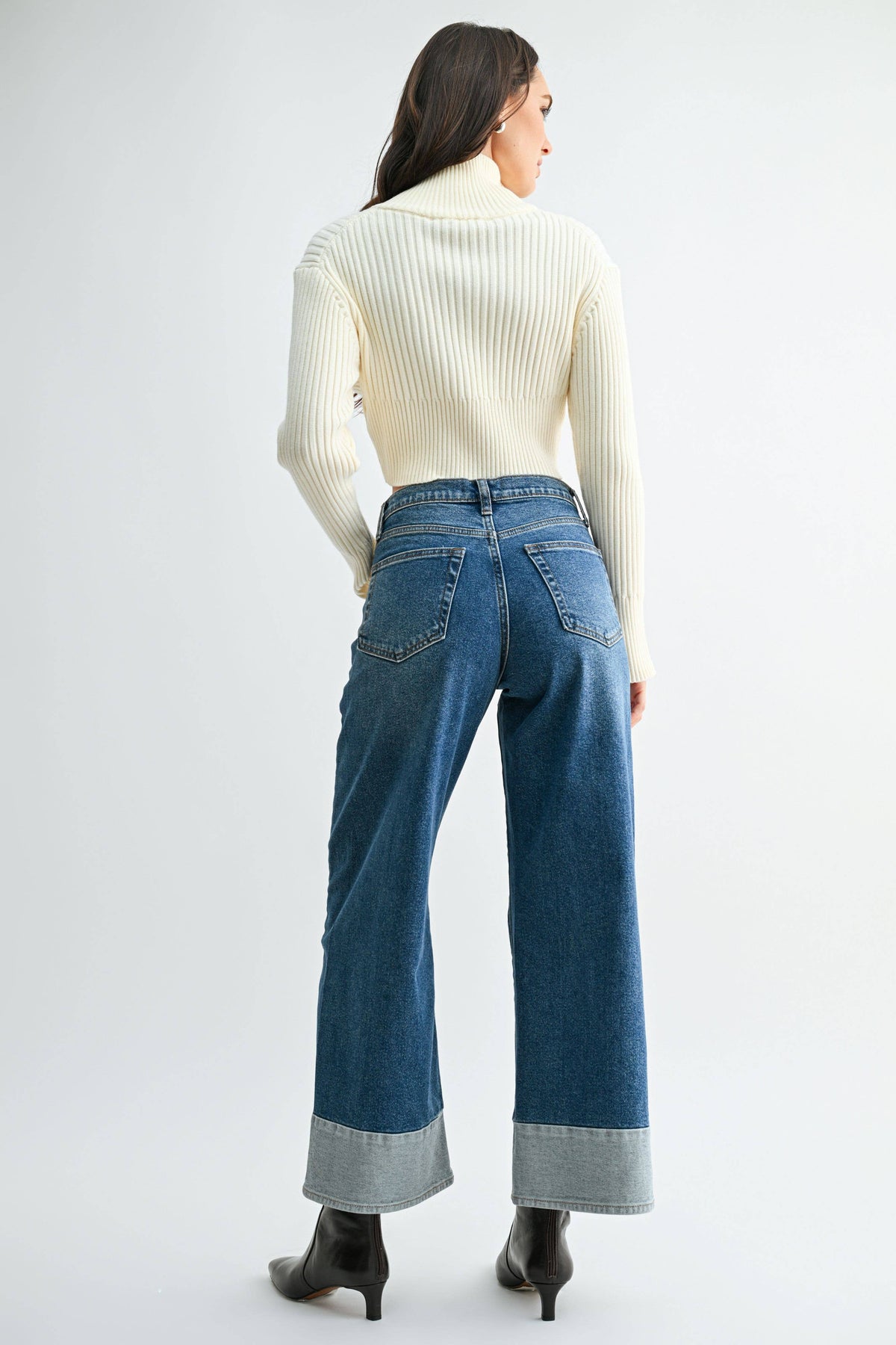 Back view of Blue Hour Two-Tone Wide Leg Jeans showing two back pockets and broad, light denim hem panels.