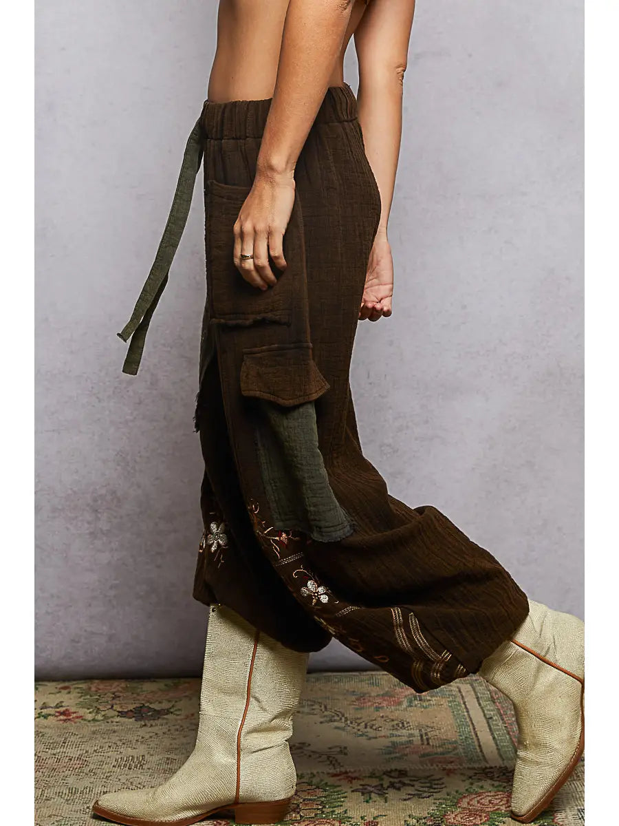 Side view, wide-leg silhouette + olive cargo pocket + floral hem embroidery + drawstring tie