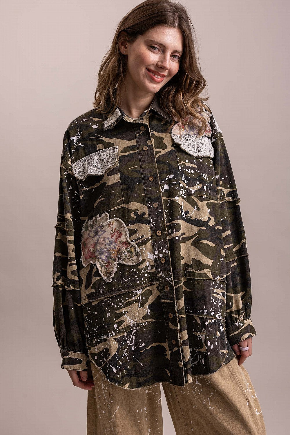 Straight-on view of BlueVelevet Off the Trail camo jacket with long sleeves, lace-trimmed pockets and floral patches.