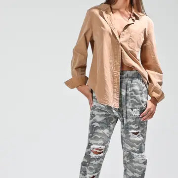Close-up front, open styling over cami + ripped camo pants
