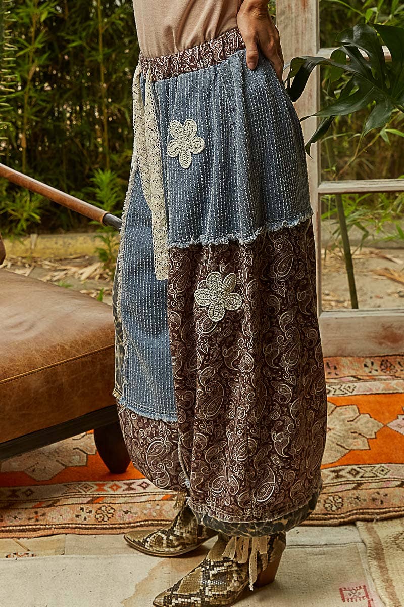 Person wearing a layered skirt with floral patterns in an outdoor setting