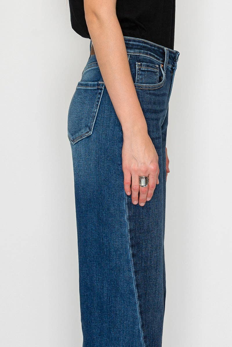 Wide flare jeans side angle close up - leg-lengthening silhouette with structured flare and premium stretch denim