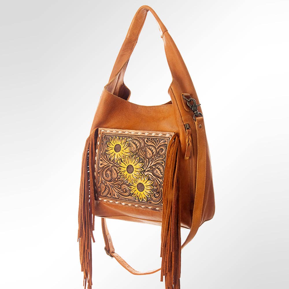 Brown leather handbag with floral embroidery and fringes on a white background