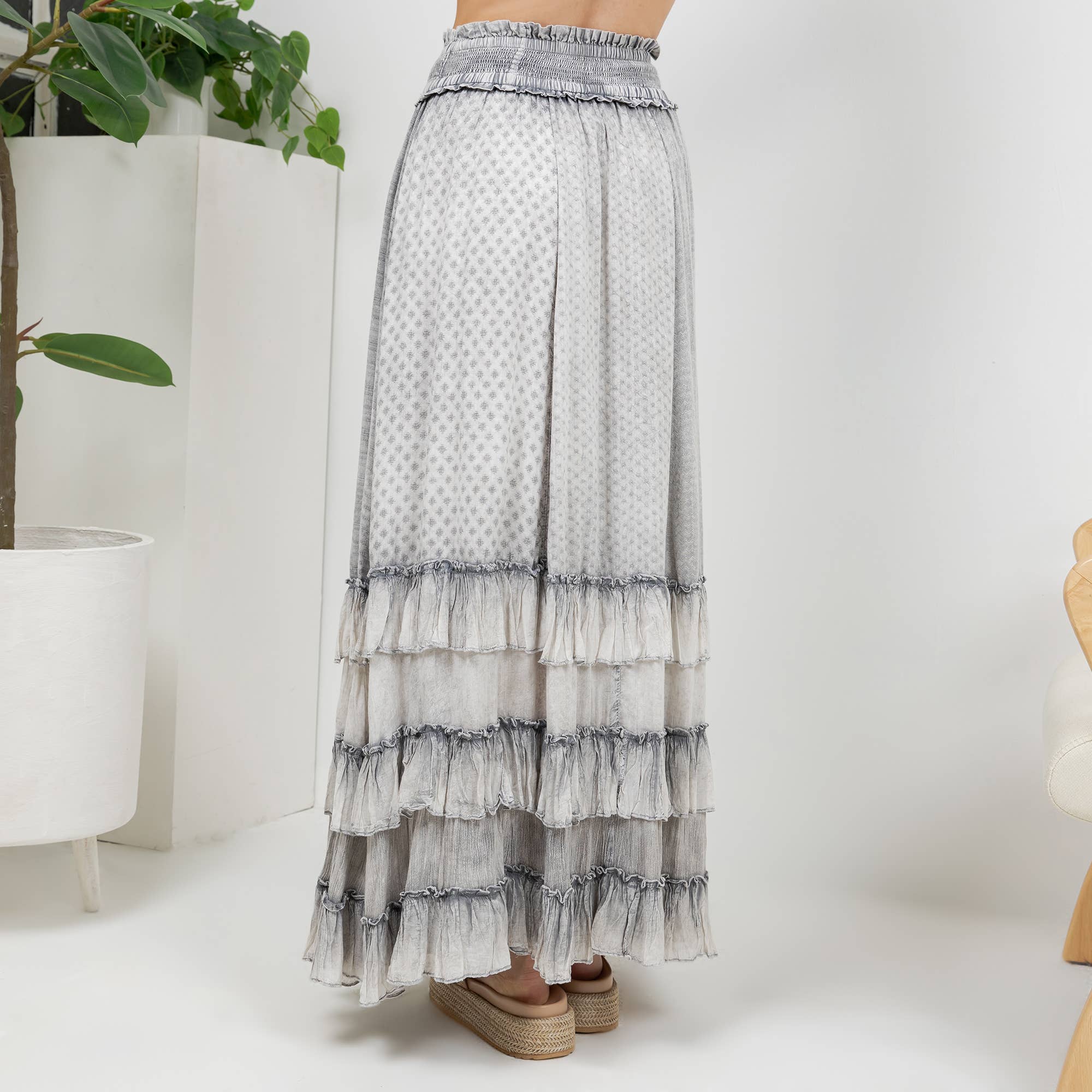 The Reverie Ruffled Tiered Maxi Skirt in Grey - back view of smocked elastic waist
