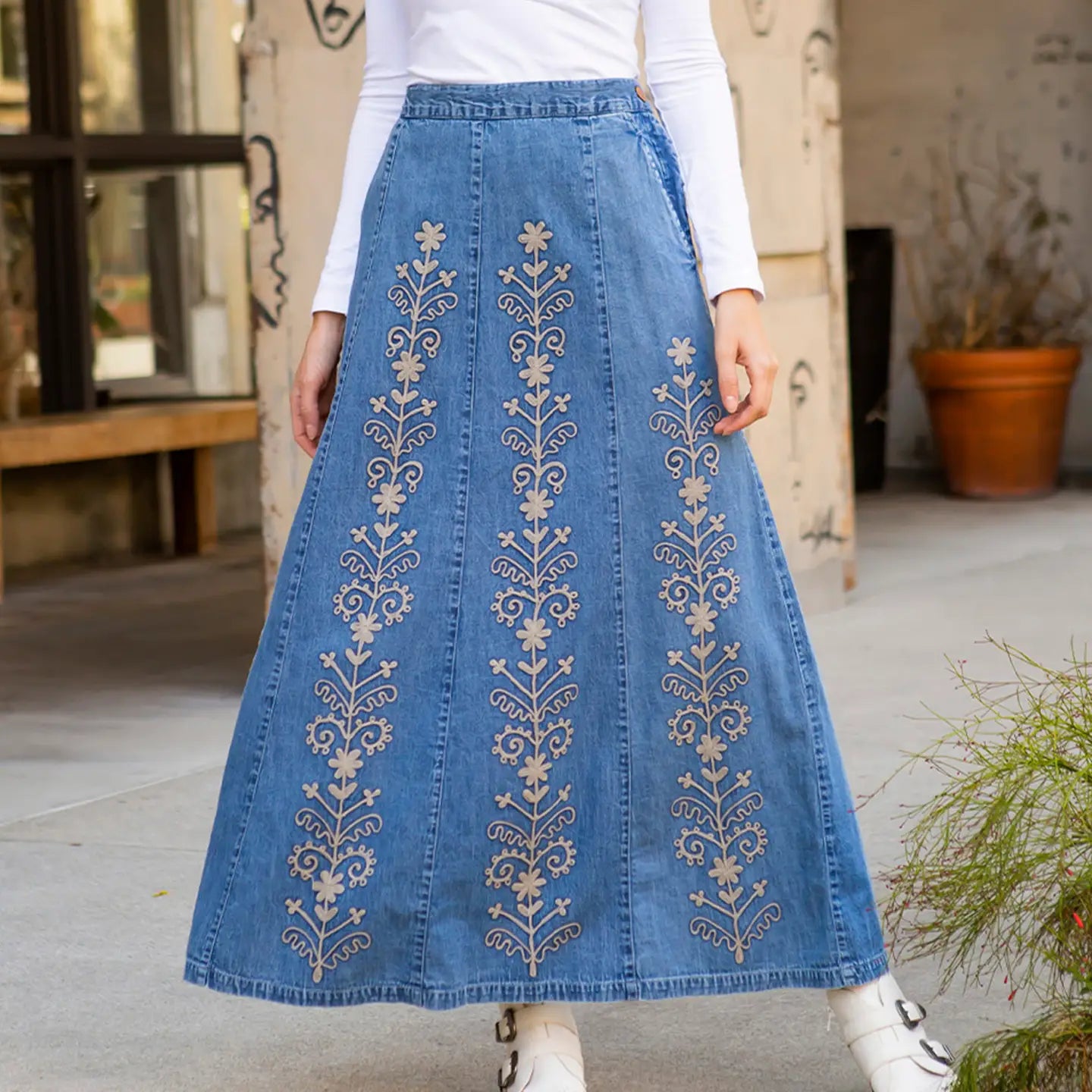 Studio front, three vertical floral vine embroidery panels, white long-sleeve
