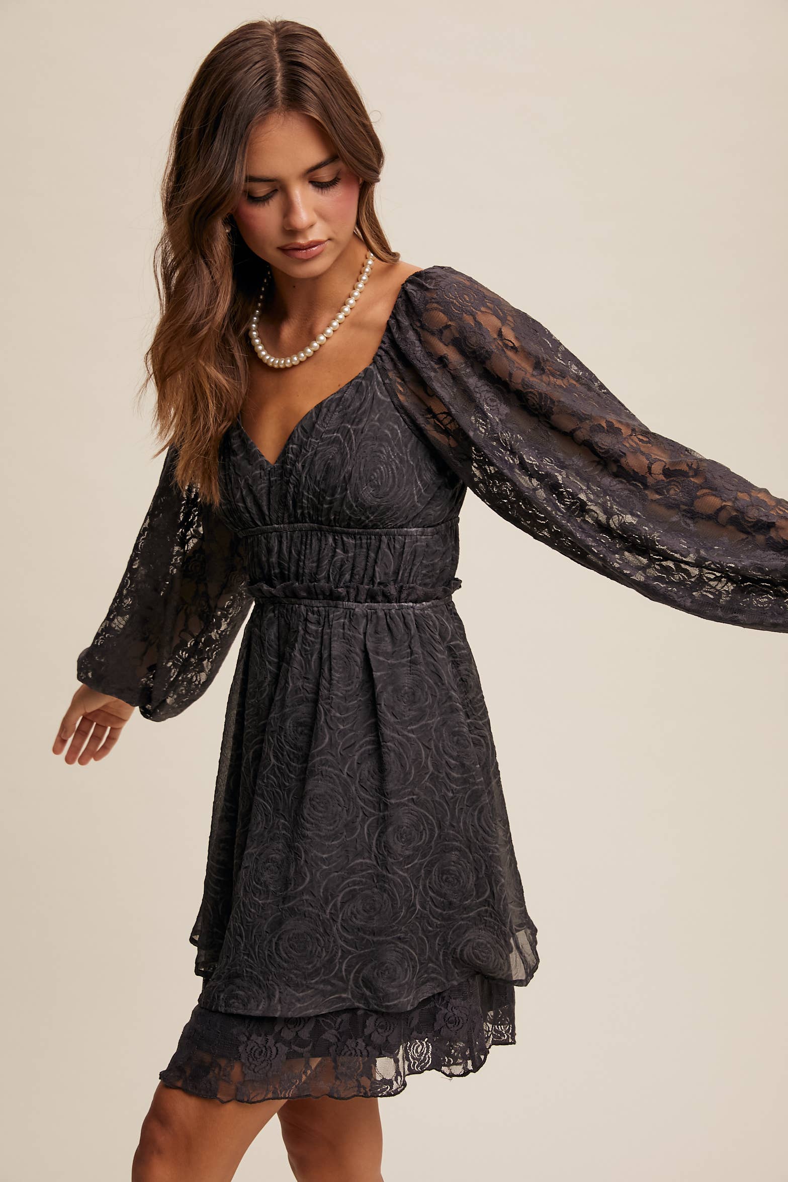 Side view of floral lace detailing and layered hem on The Midnight Lace Dress