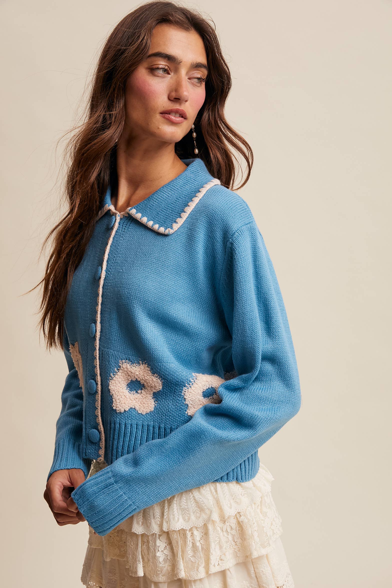 Women’s floral collar knit cardigan with button-front design, soft textured fabric, and contrast flower-patterned collar — stylish layering sweater for everyday wear.